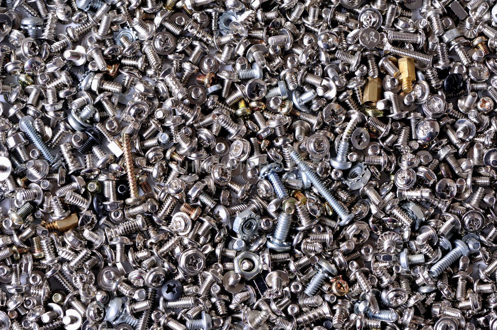 Background from small metal bolts, screws and nuts by fotooxotnik