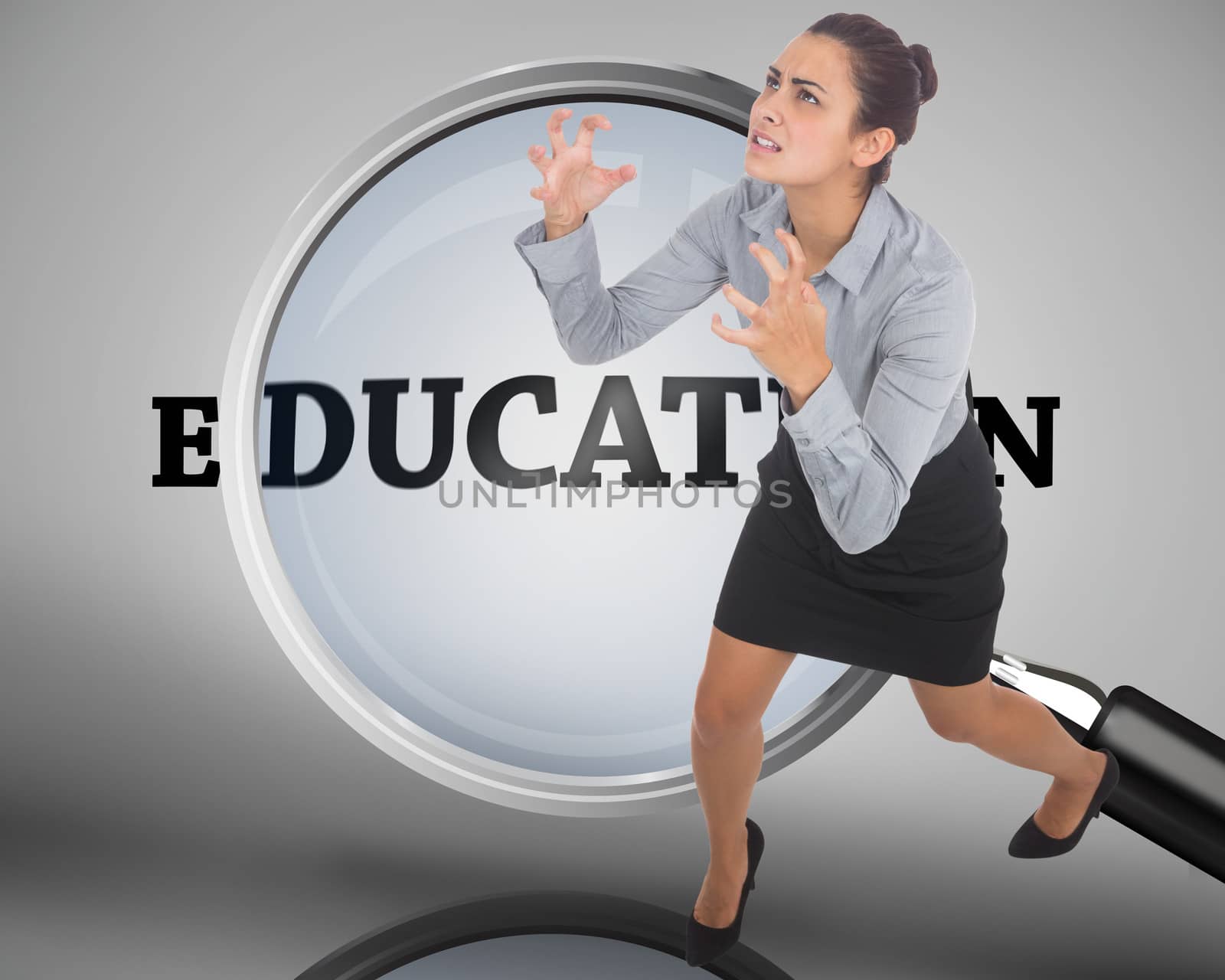 Furious businesswoman gesturing against magnifying glass showing education word