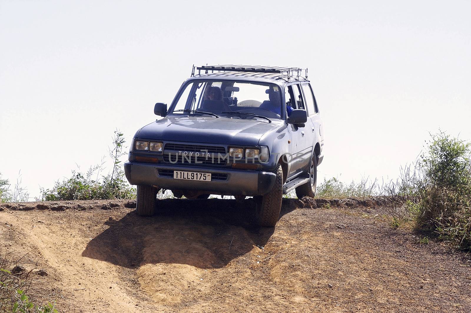 French tourists and their driver in the middle of the bush in Burkina Faso