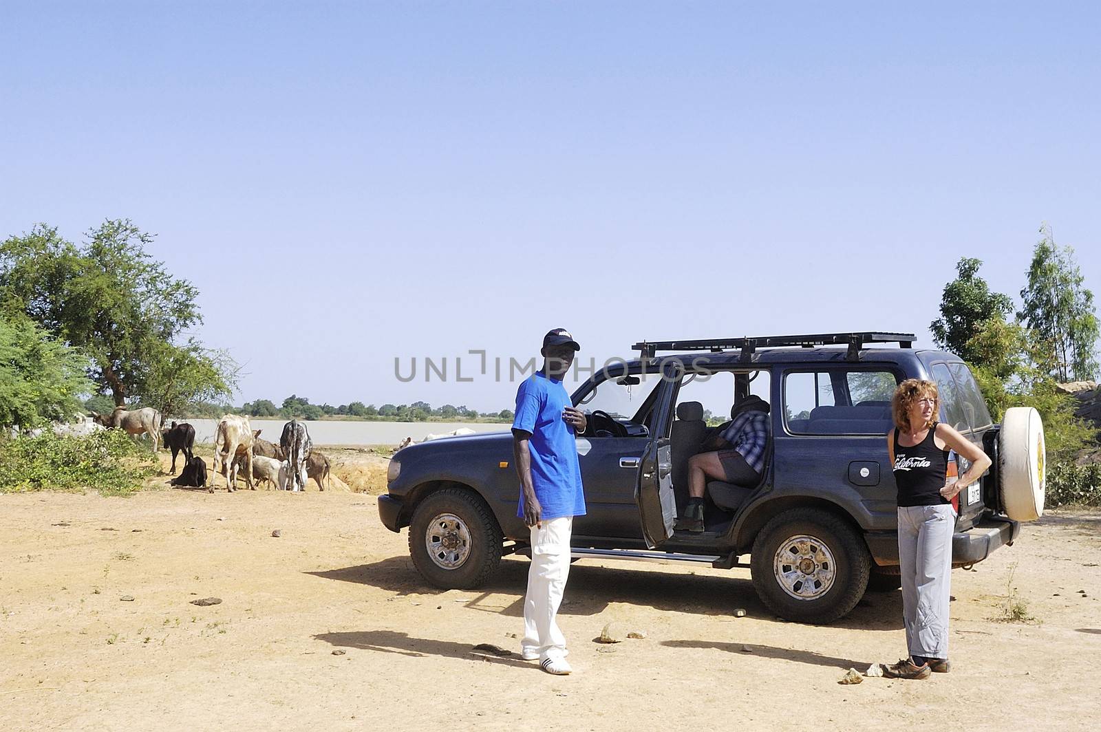 French tourists and their driver in the middle of the bush in Burkina Faso