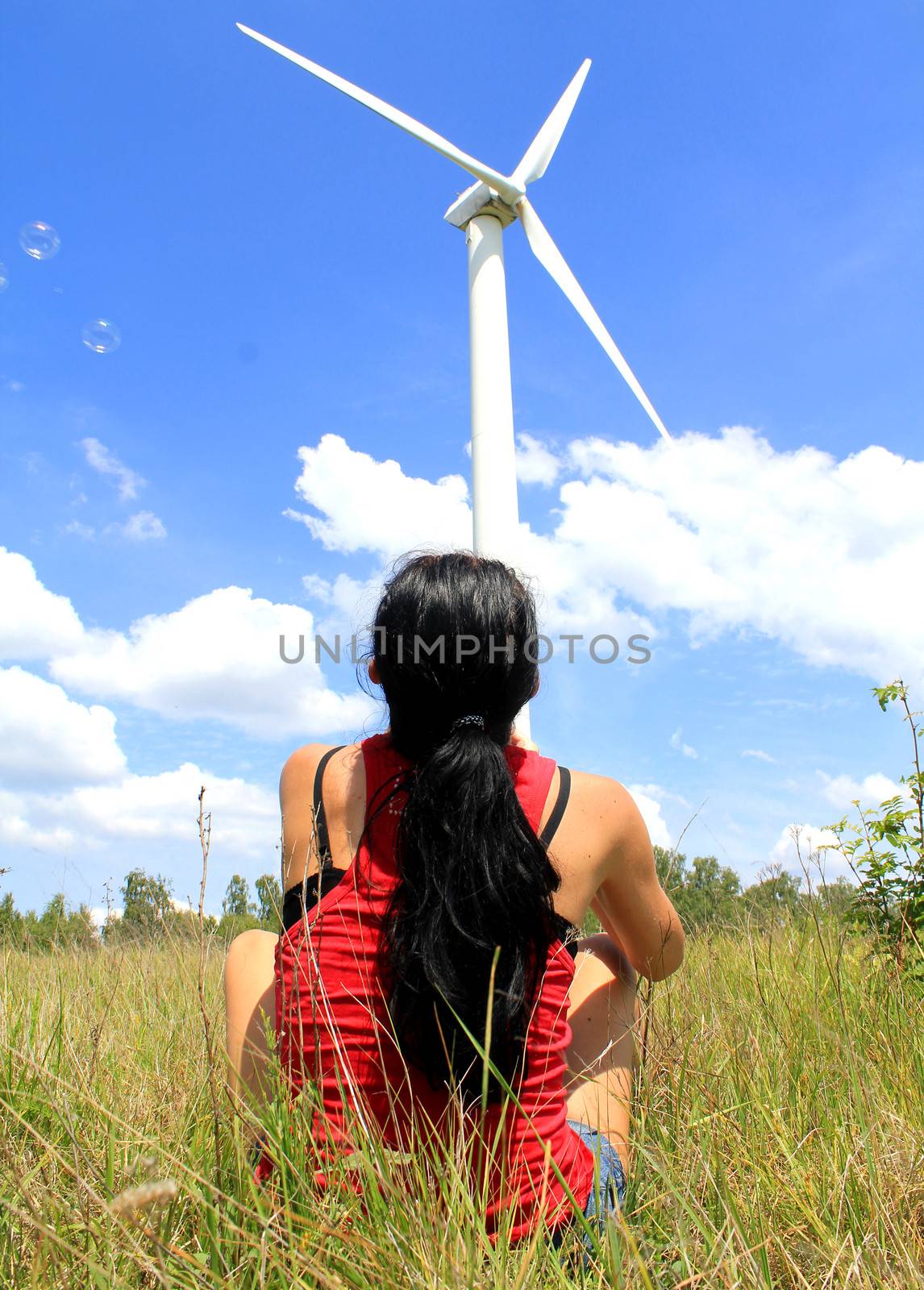 girl near a wind turbine