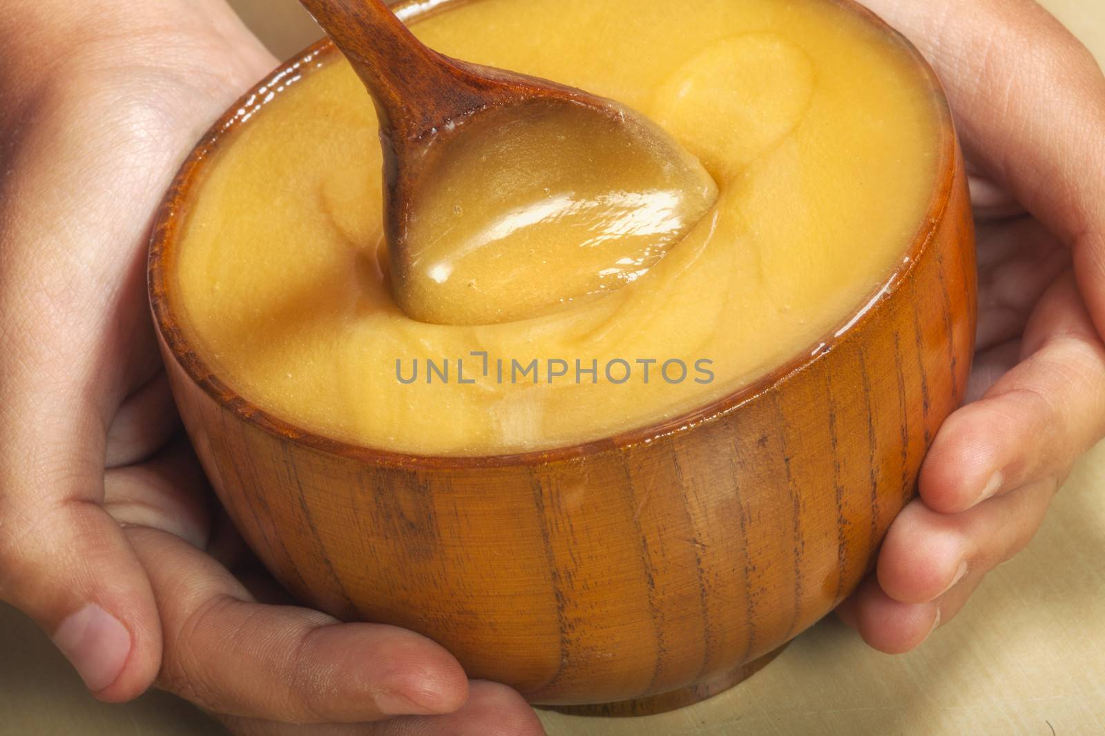 pot of honey in the hands of