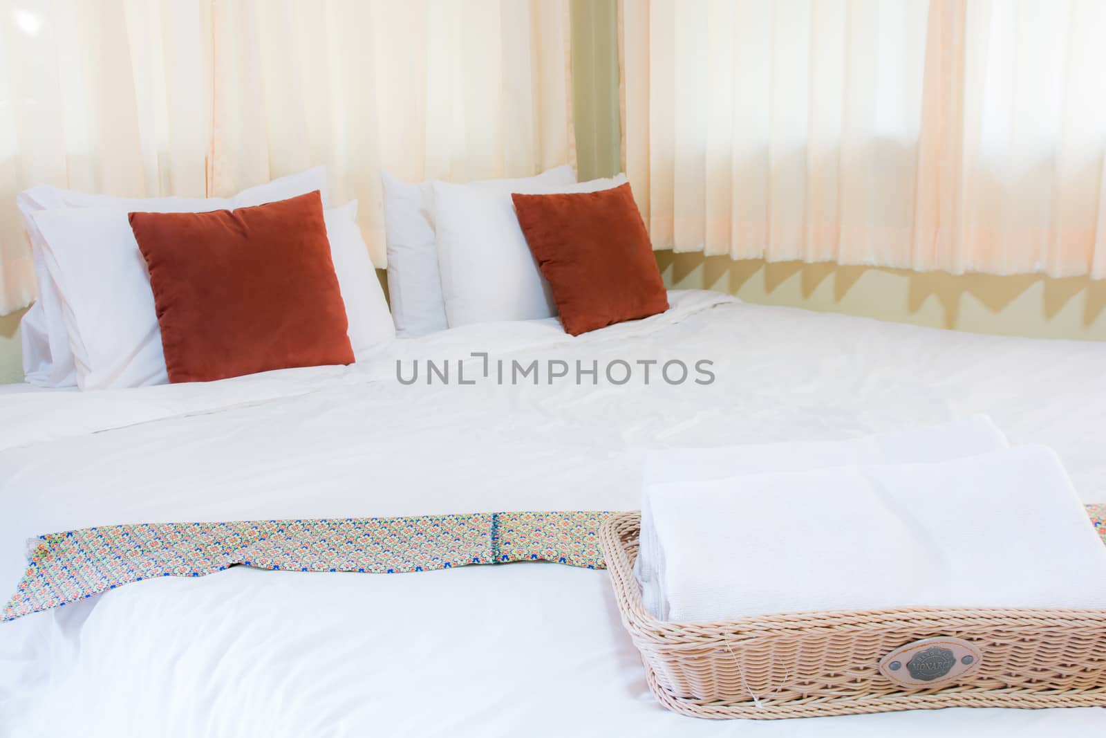 Bed in hotel room at day and sunlight