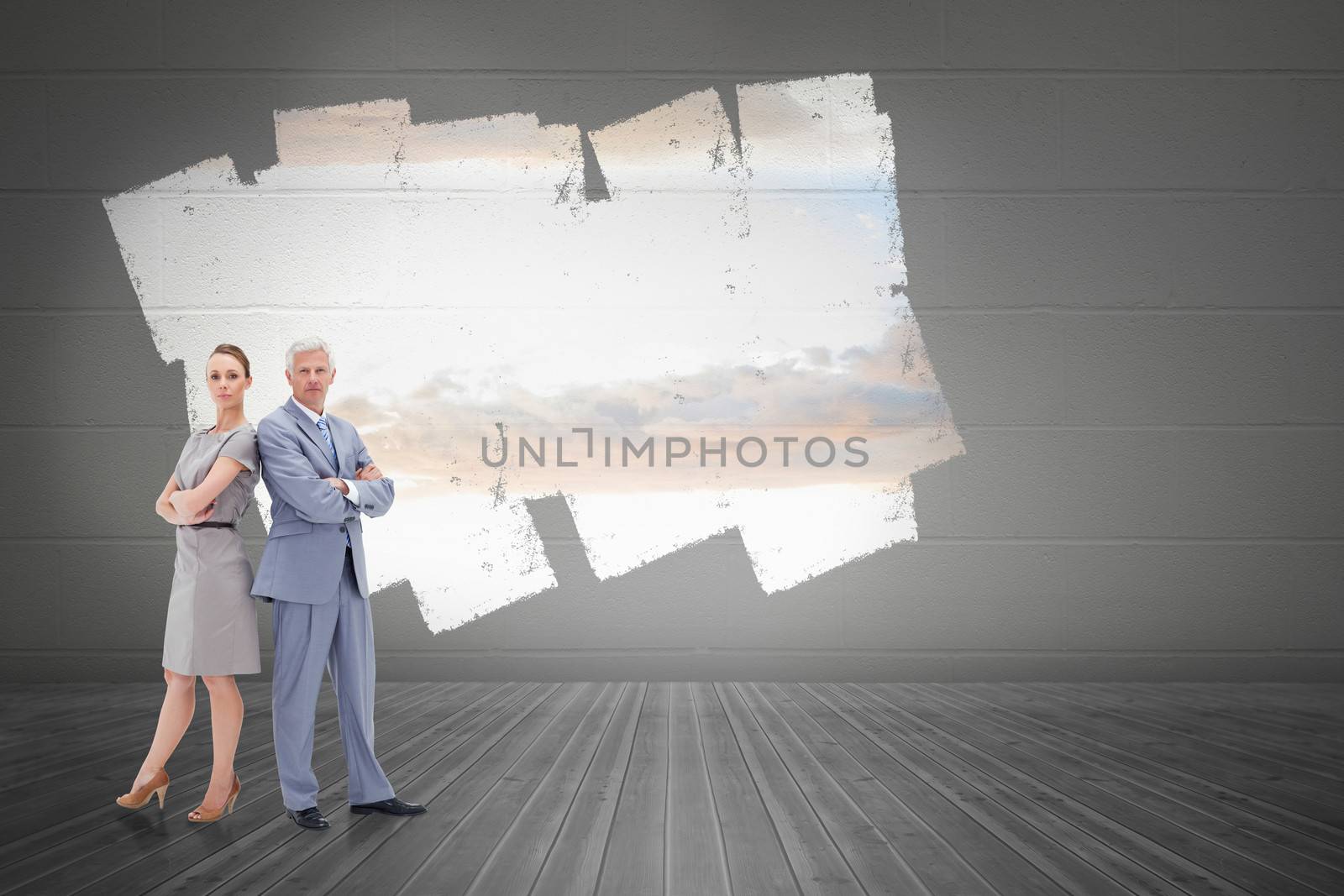 Composite image of serious businessman standing back to back with a woman  by Wavebreakmedia