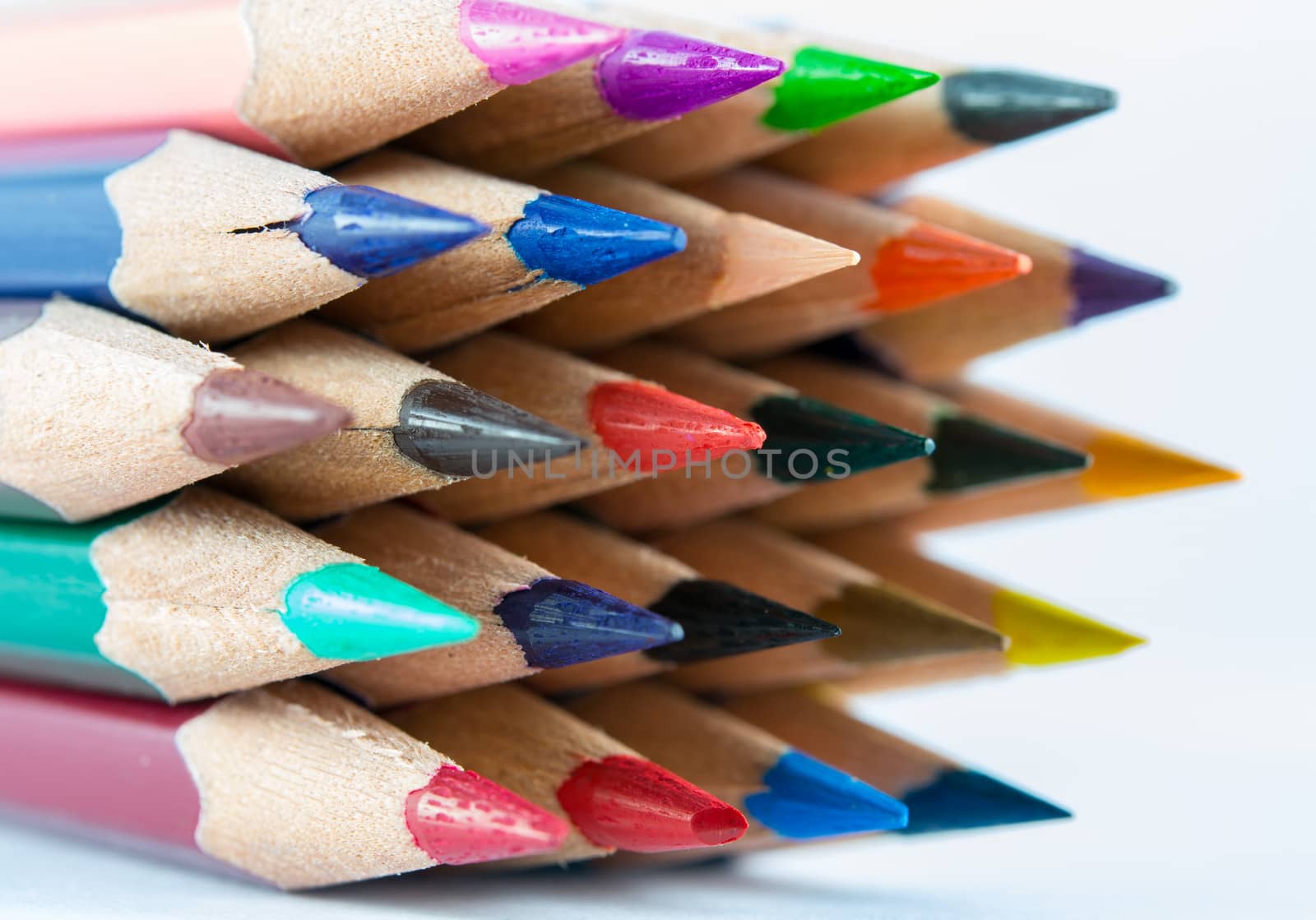 pointed color pencils and a white background