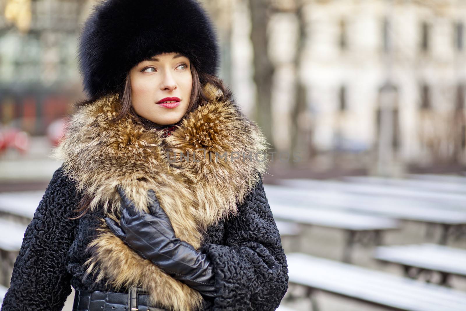 Winter girl wearing expensive real fur and leather gloves in autumn