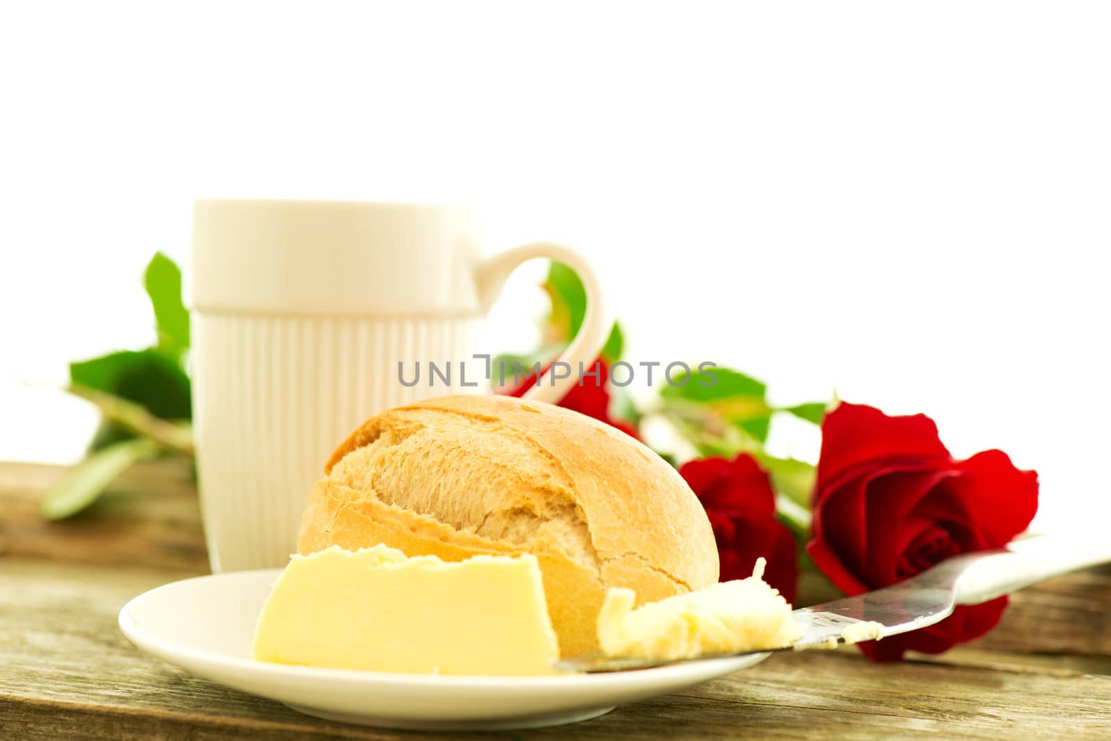 Bread butter and roses on wooden table - romantic breakfast  composition