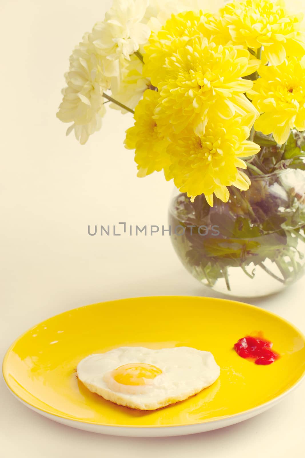 Breakfast. Fried eggs in a heart-shaped bouquet of chrysanthemums near
