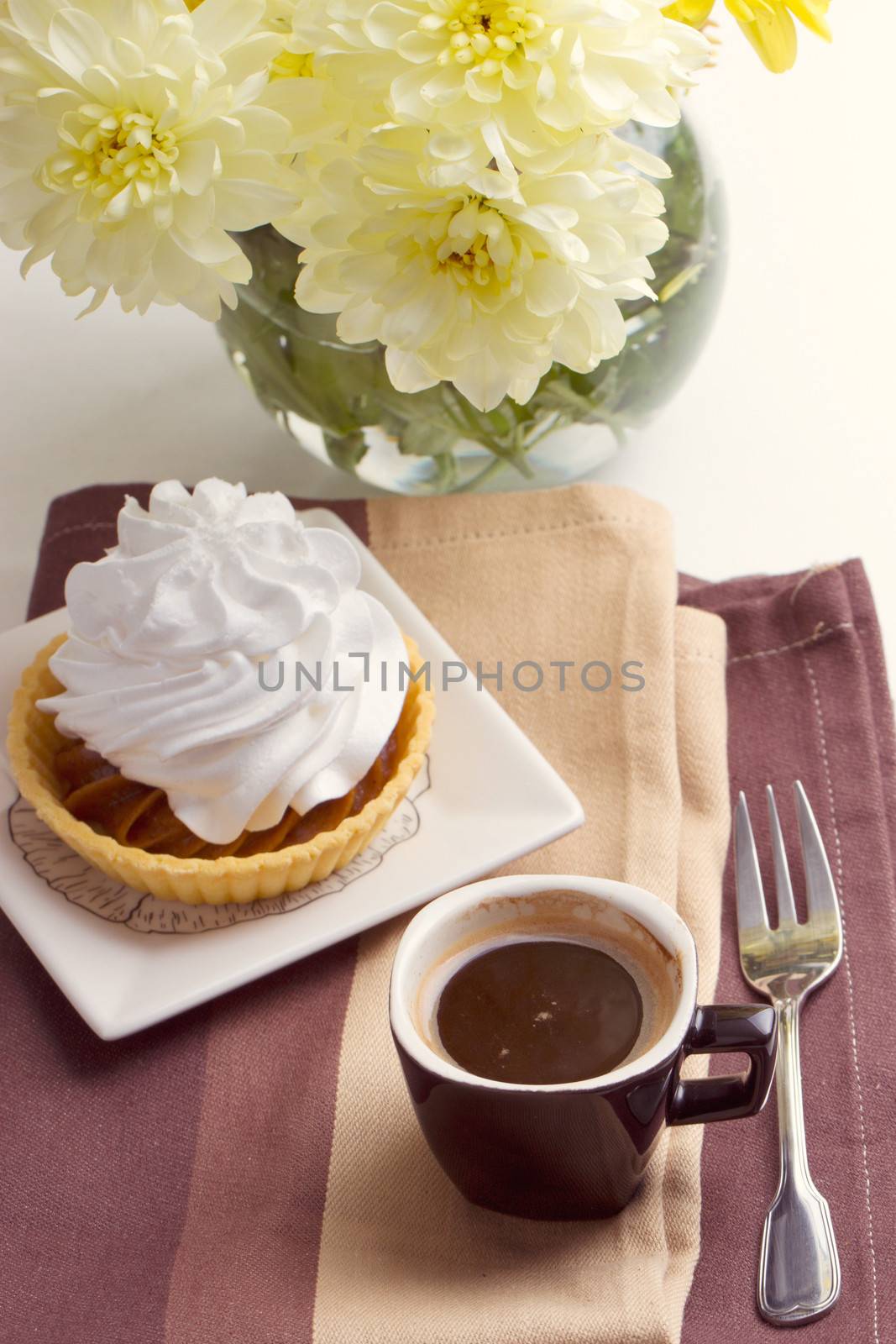 Coffee and cake with whipped cream near chrysanthemums