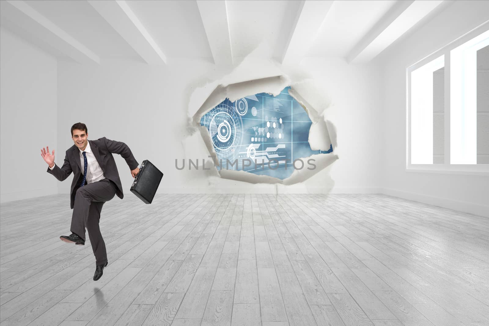 Happy businessman in a hury against rip on wall showing technology interface