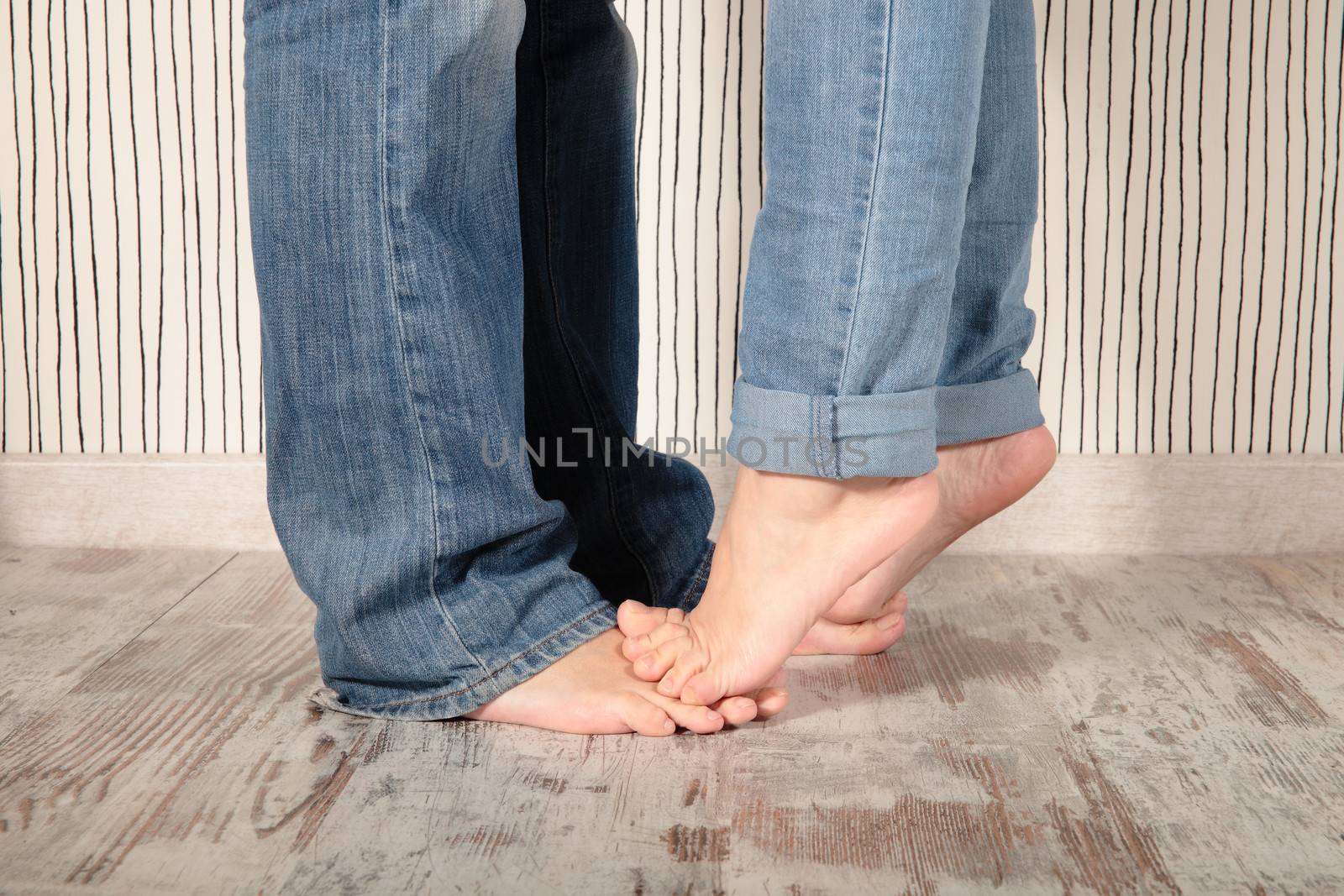 legs of kissing couple on a bedroom
