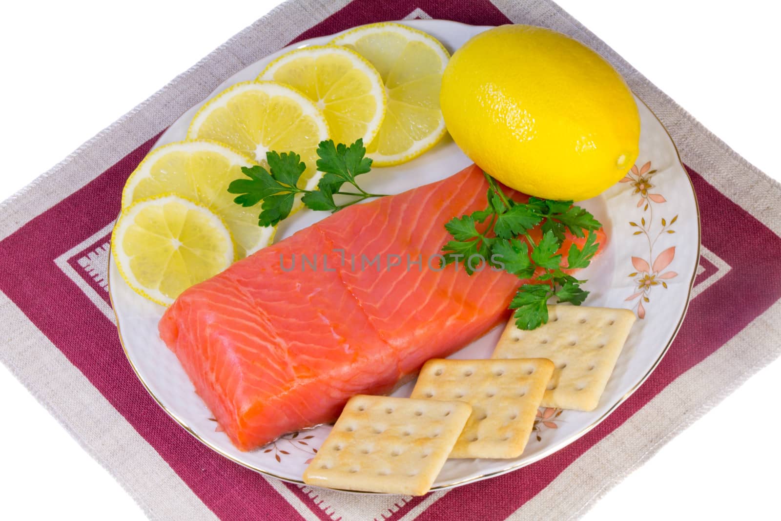 Salmon fillet and lemons on a platter on a white background. by georgina198