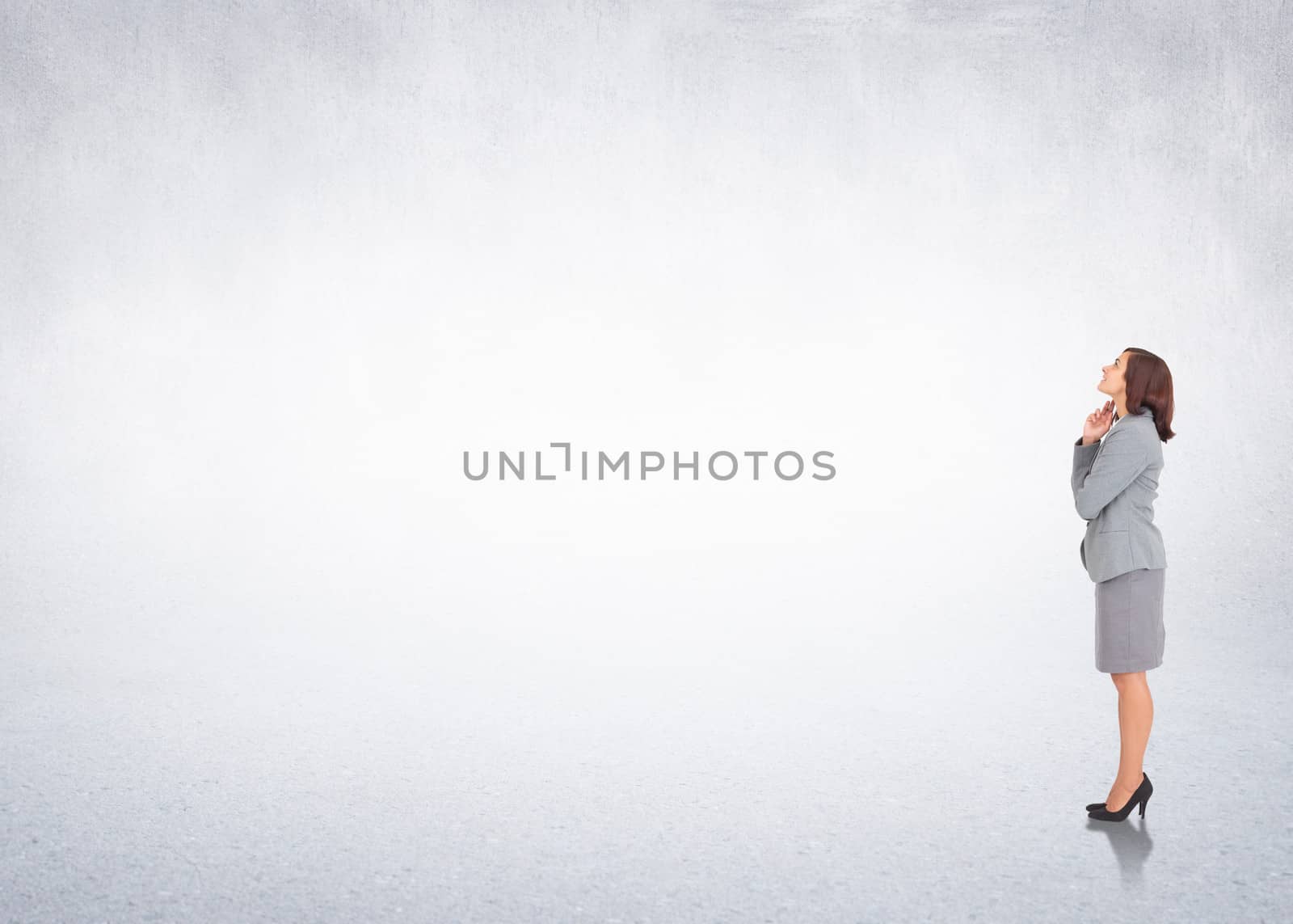 Composite image of smiling thoughtful businesswoman by Wavebreakmedia