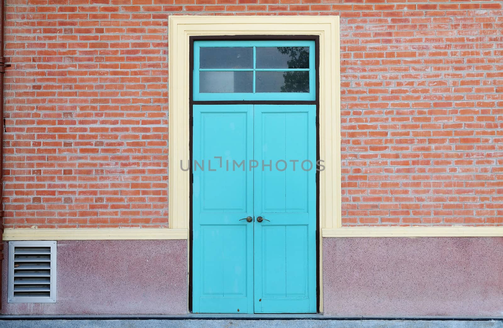blue wooden door and brick wall