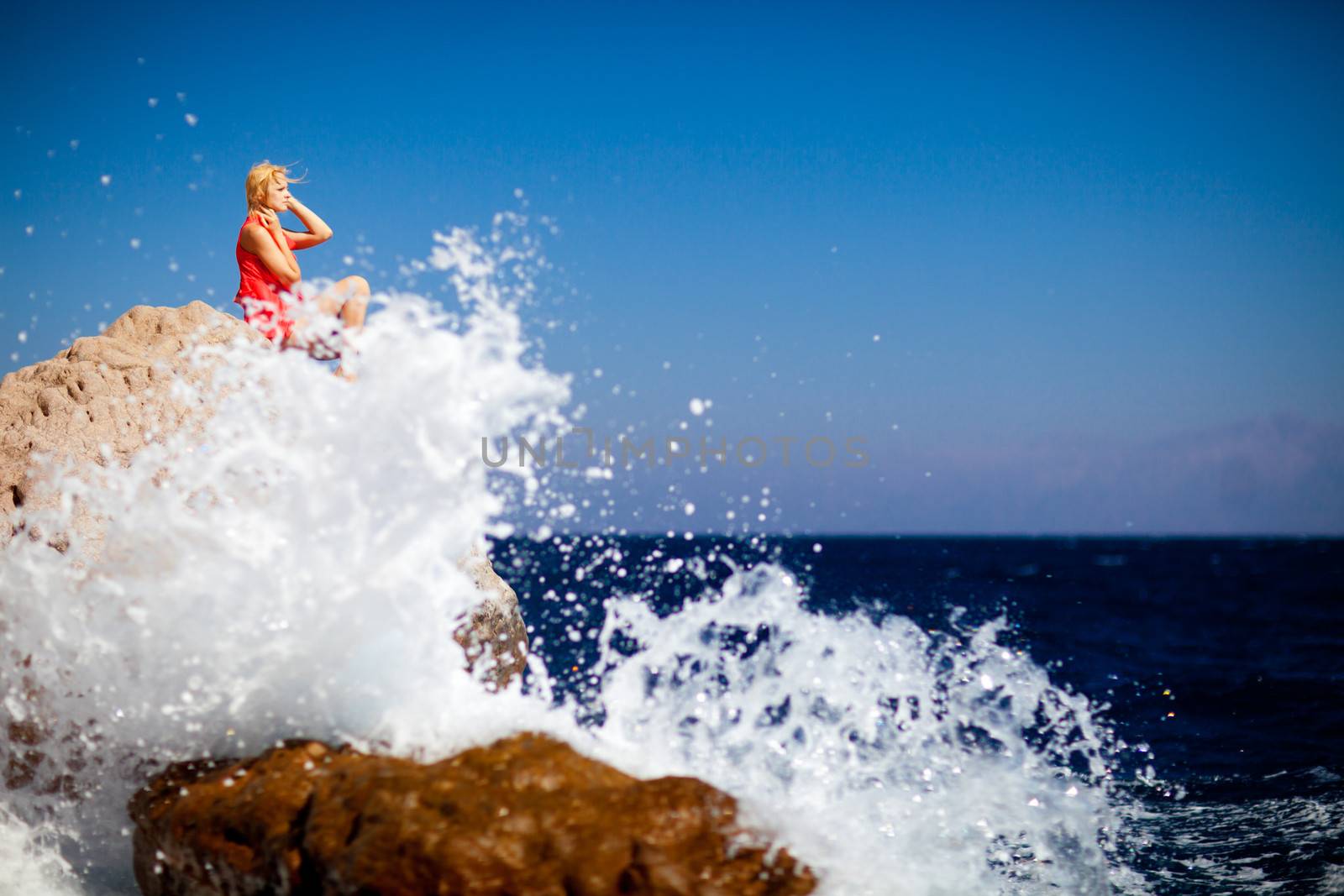 girl on the rock in the sea by vsurkov