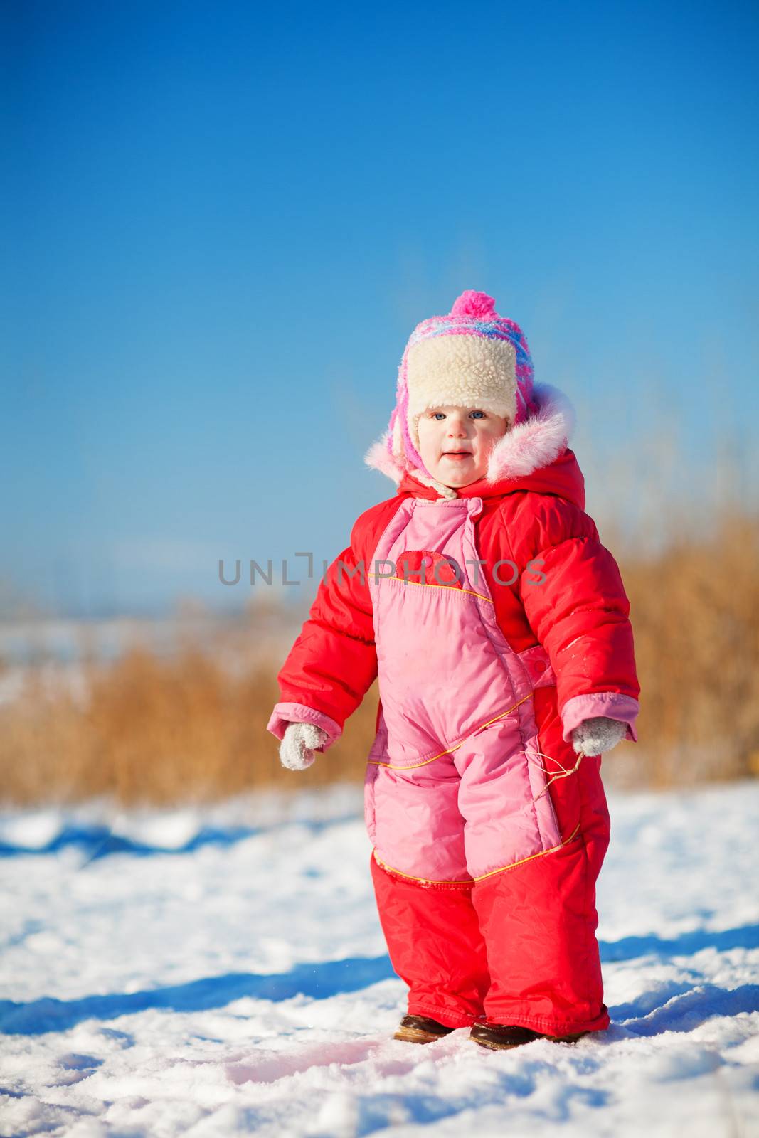 child in winter outdoors by vsurkov