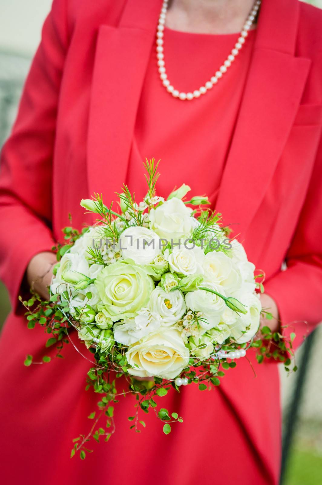 Bride with red dress holding wedding bouquet