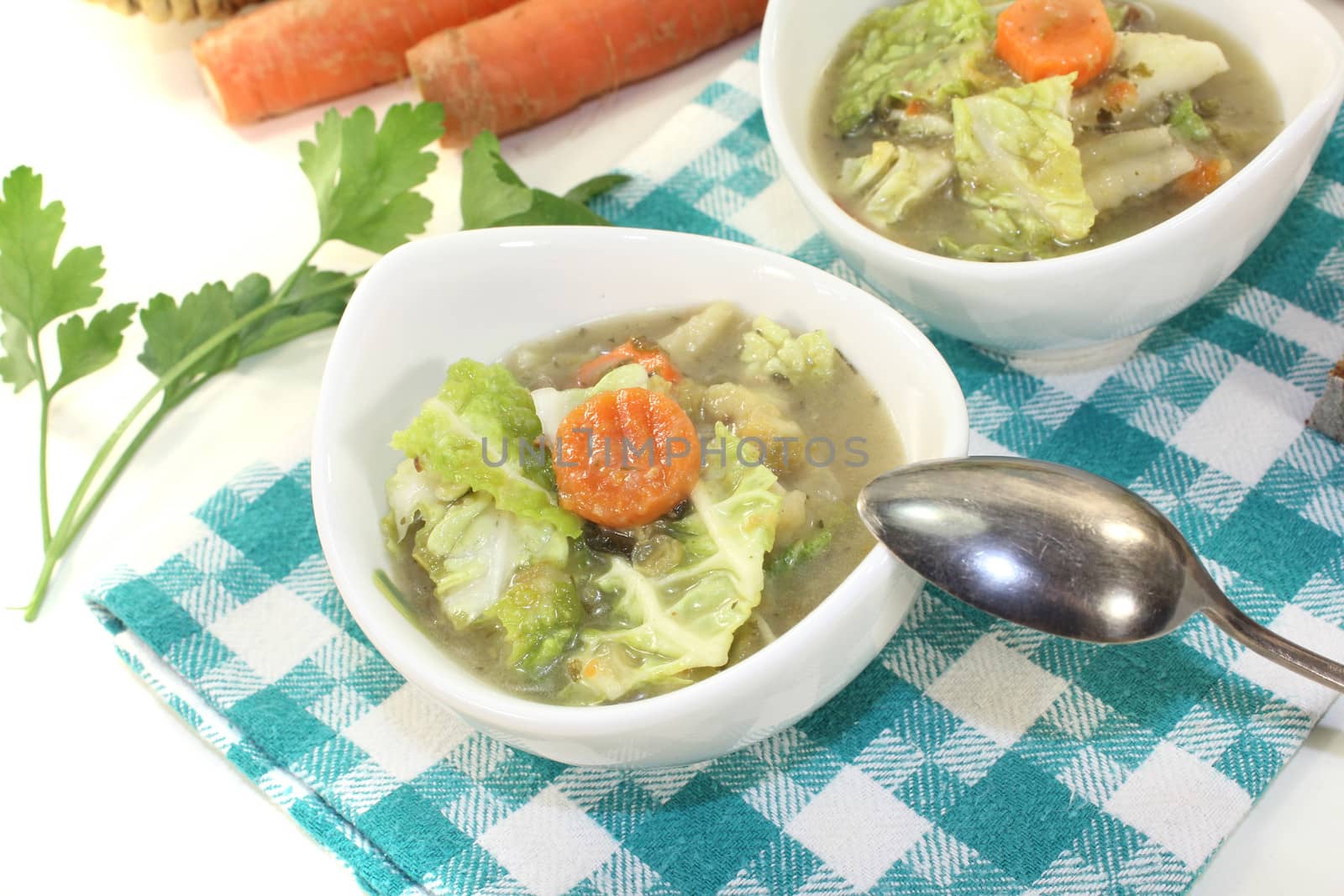 Savoy cabbage stew with parsley on a light background