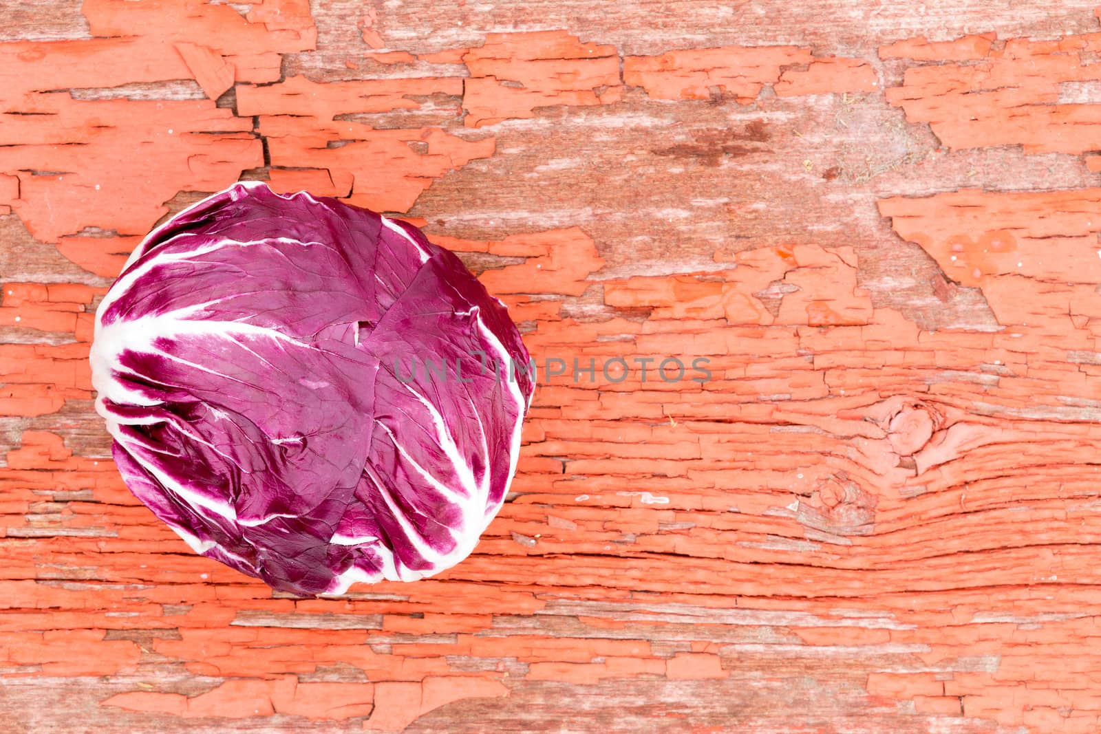 Variegated radicchio on grungy rustic wood by coskun