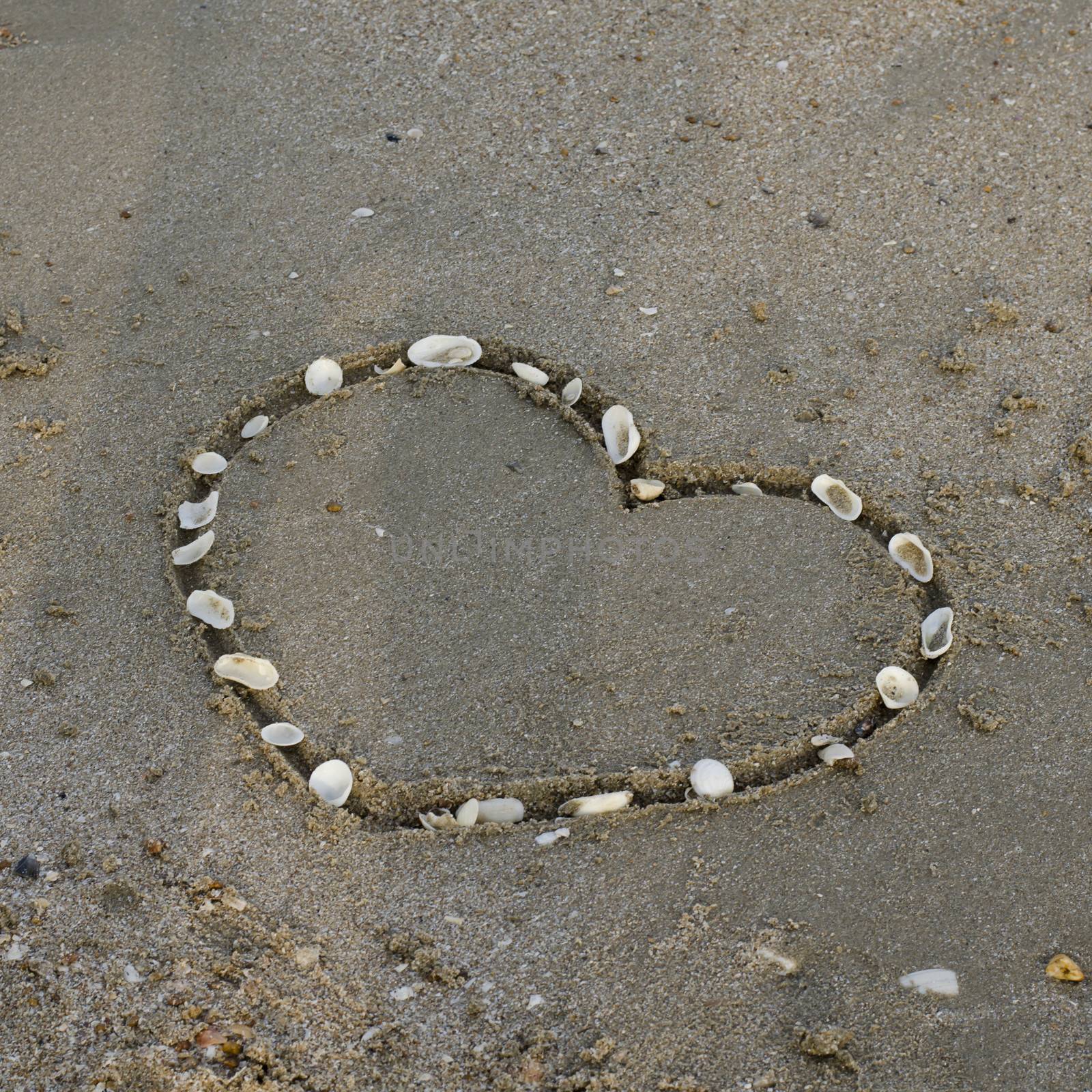 a heart on the sand in the beach by ammza12