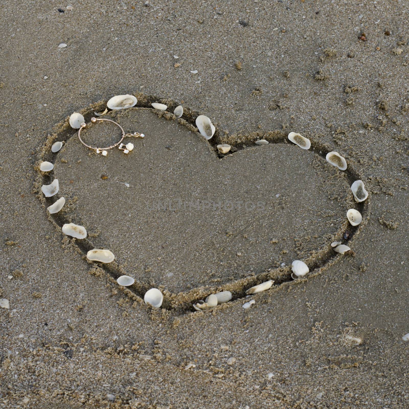 a heart on the sand in the beach by ammza12