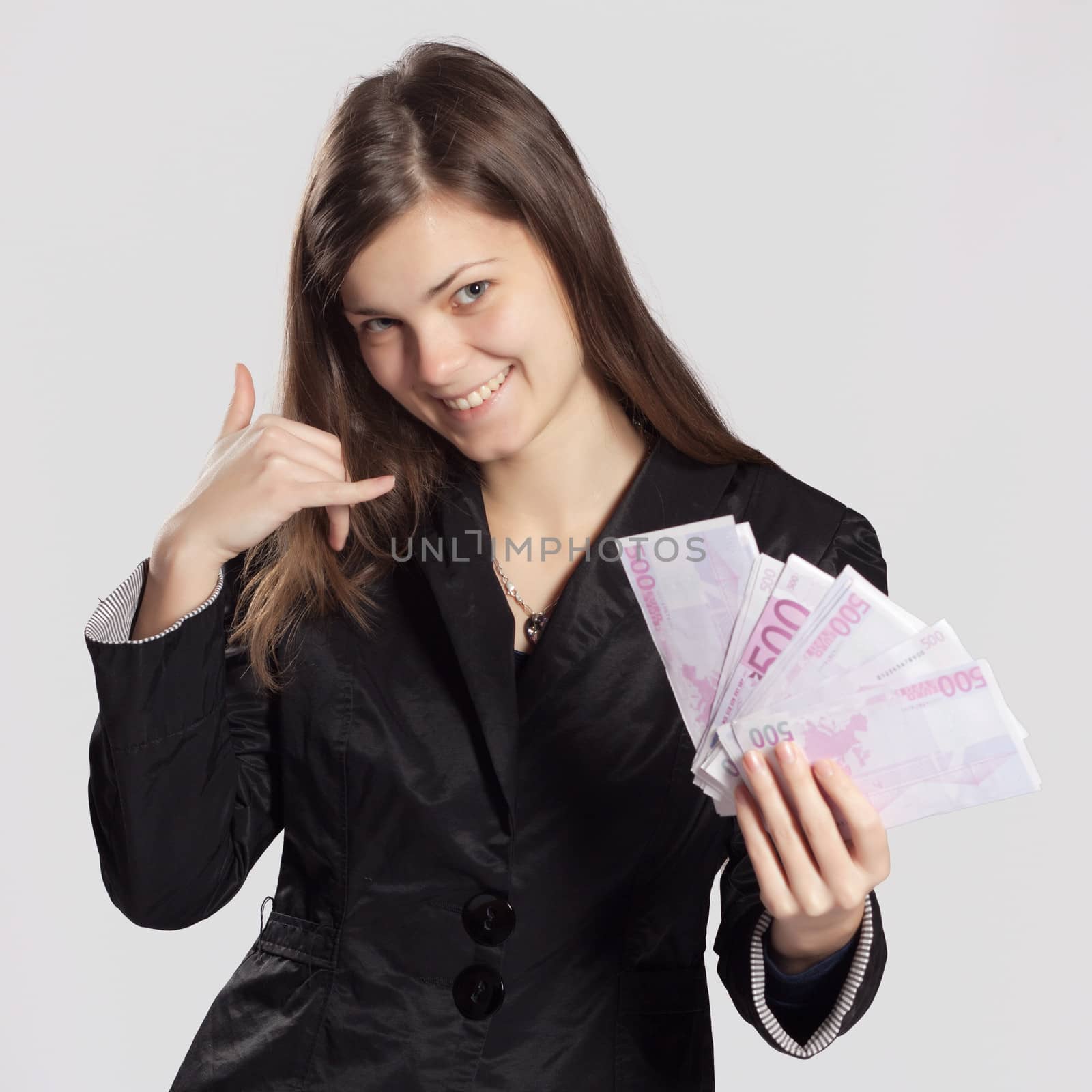 Young long-haired woman holding euros in a fan-shape in his hand and a second hand gesture call me