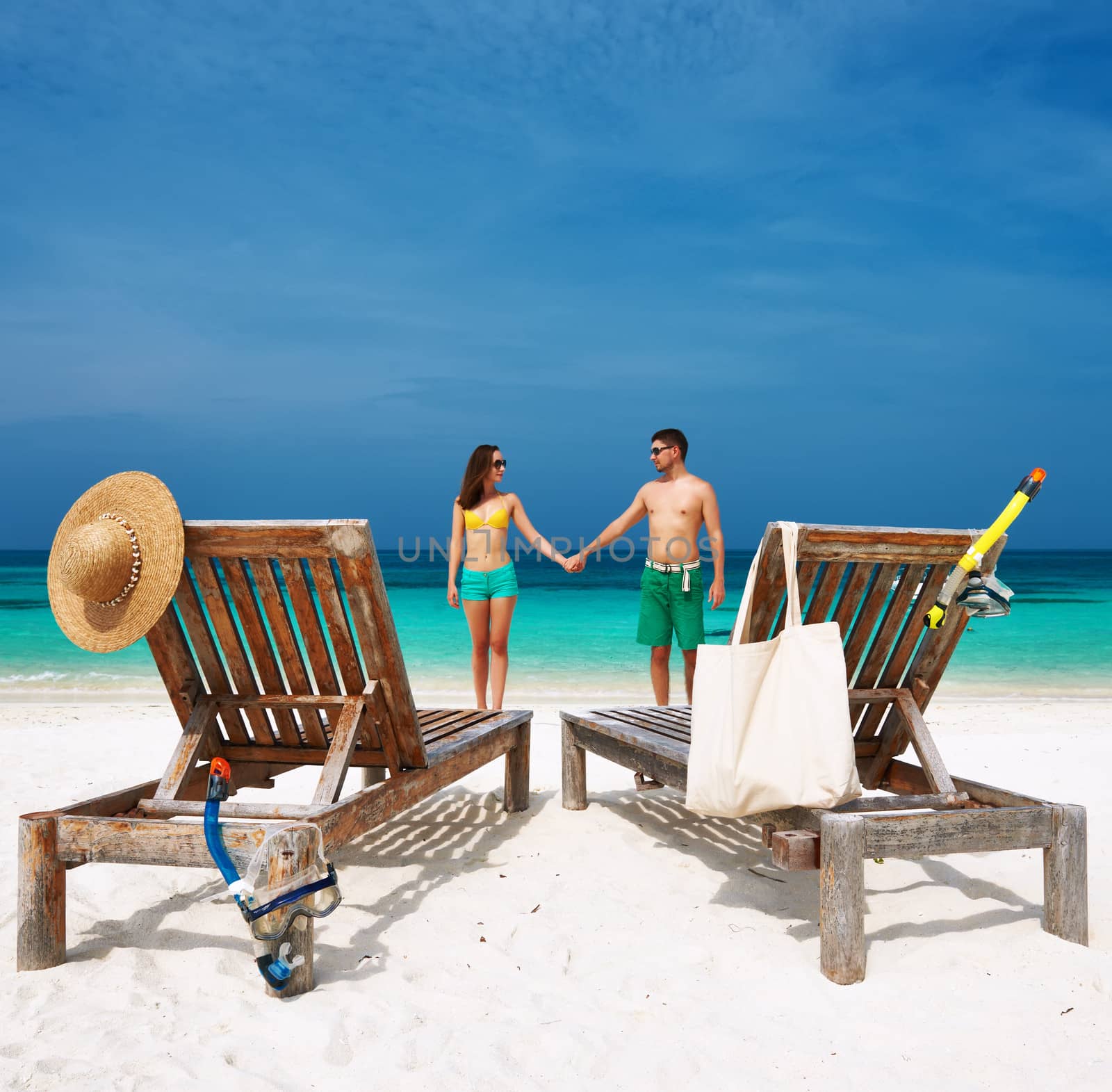 Couple in green on a tropical beach at Maldives