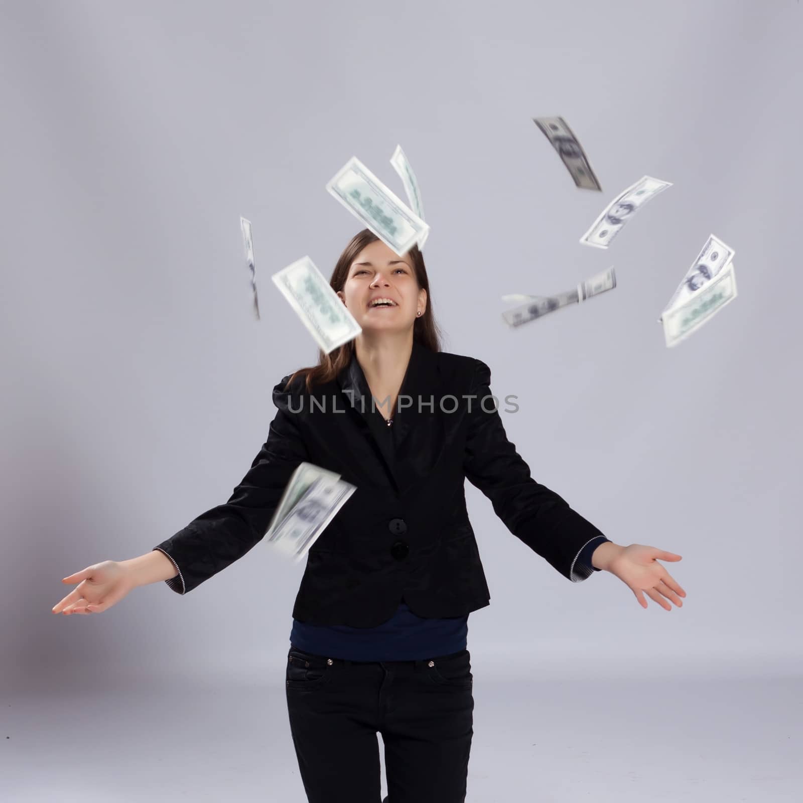 Young long-haired woman throws dollars up to