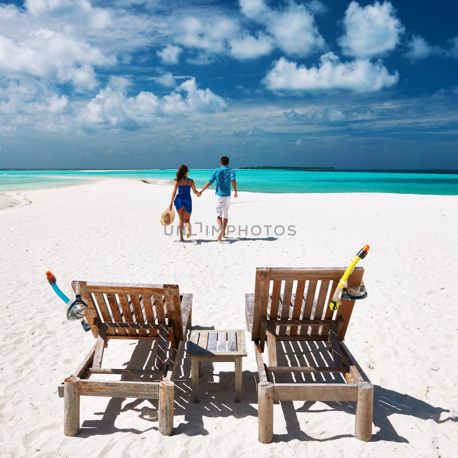 Couple running on a tropical beach at Maldives