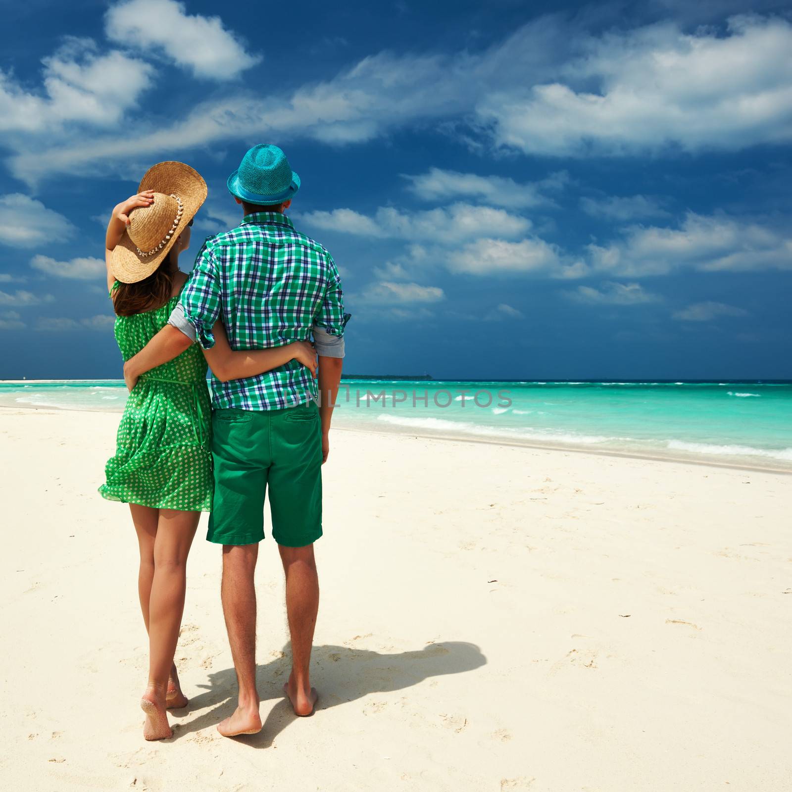 Couple in green on a tropical beach at Maldives