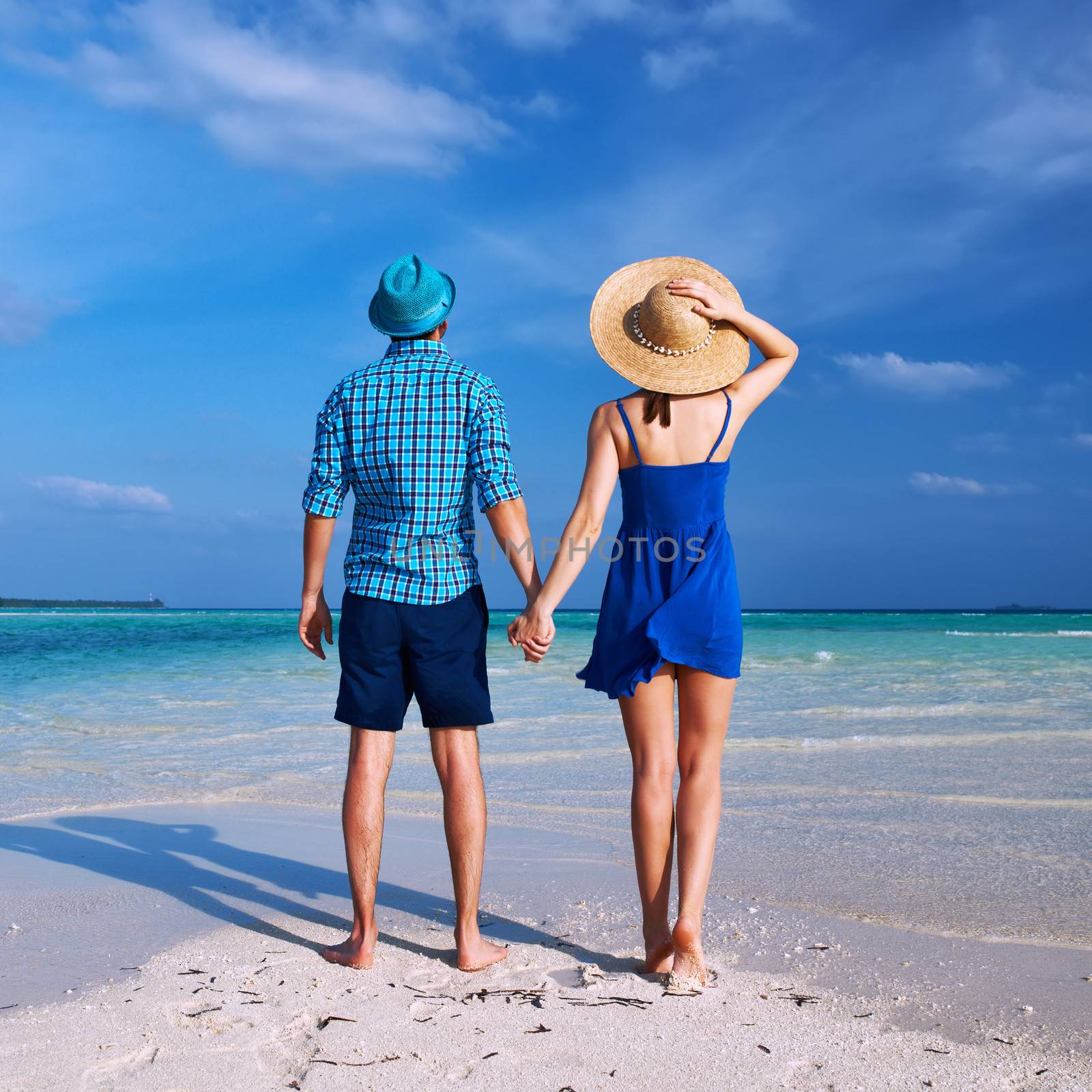 Couple in blue on a beach at Maldives by haveseen