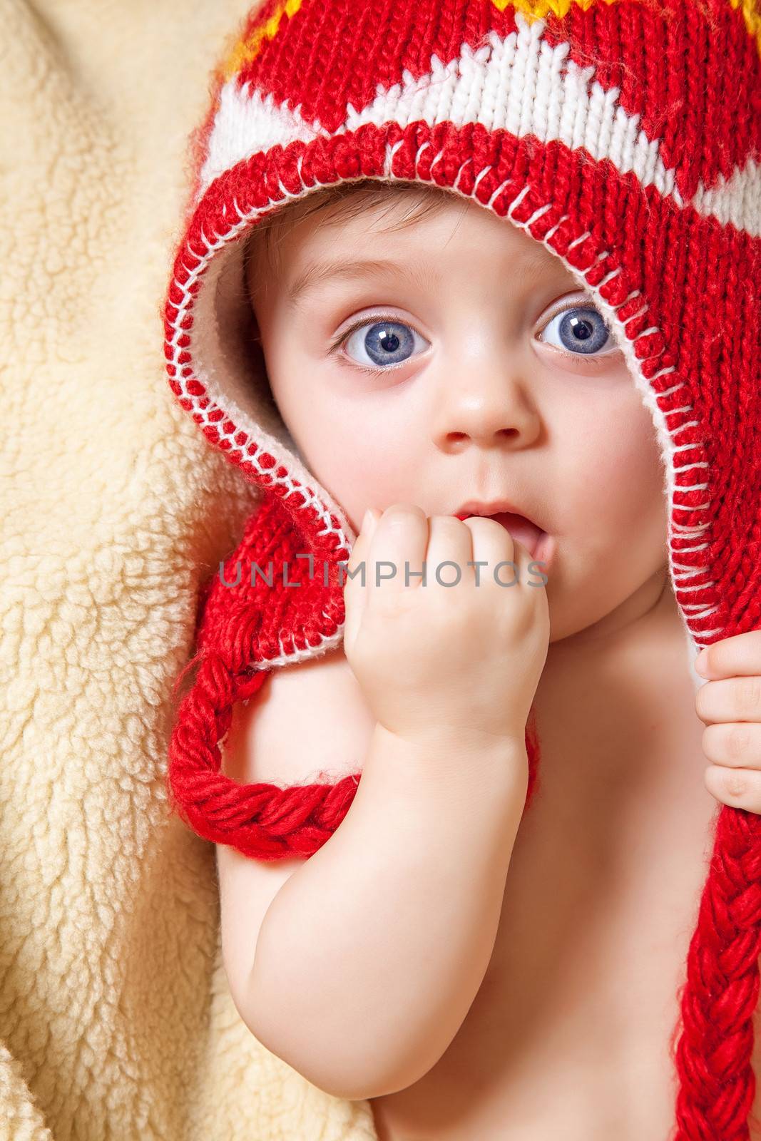 Blue eyed baby in red bonnet