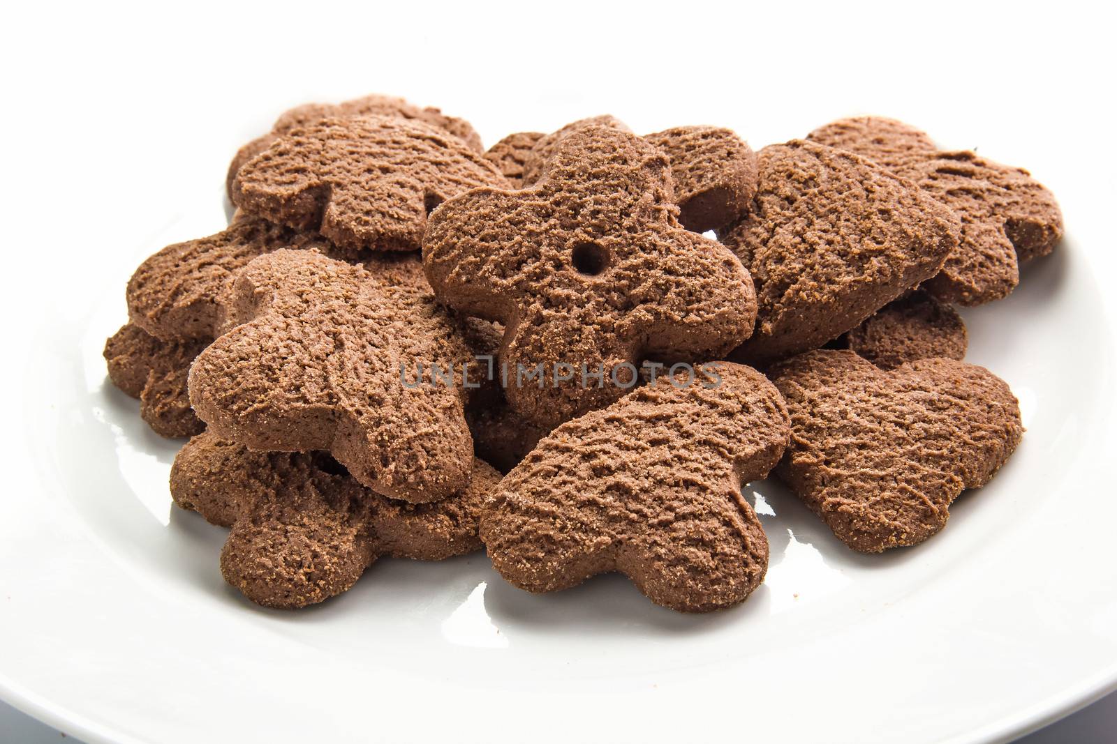 Several chocolate cookies over white dish