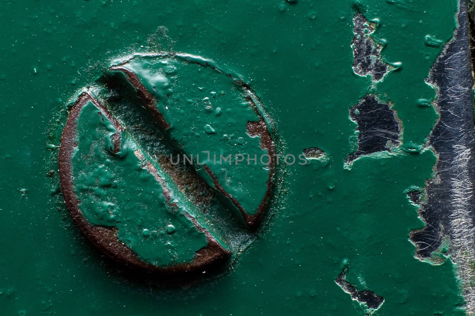 Background of a green painted rusty screw