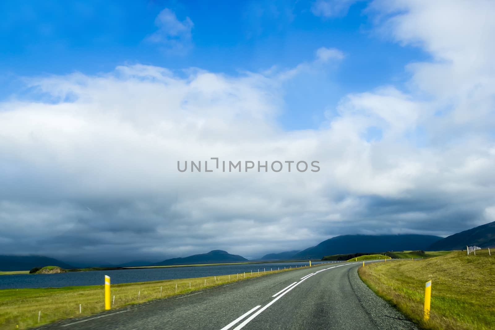 Road against mountain background, Iceland, cloudy summer weather