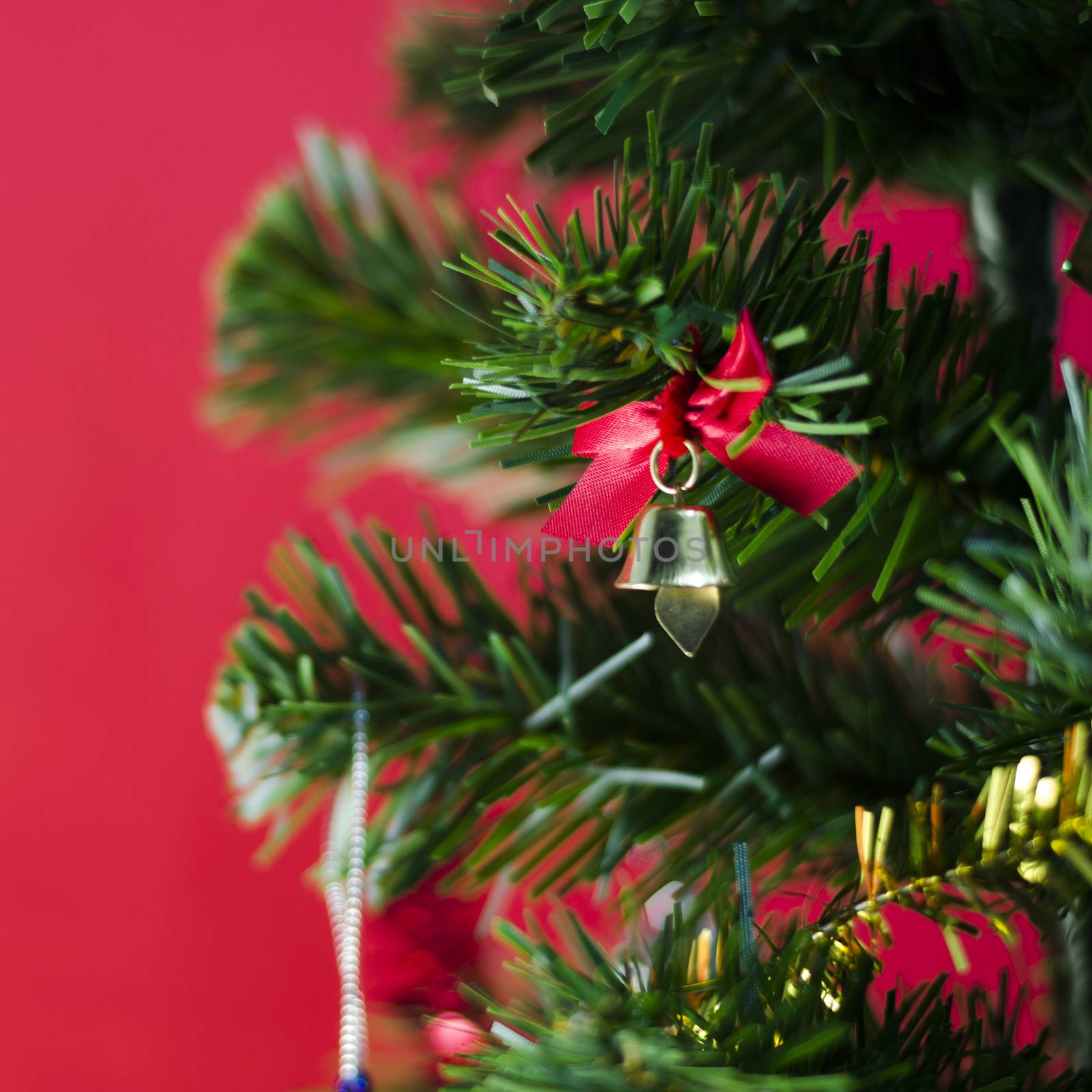 small bell on christmas tree on red background by ammza12