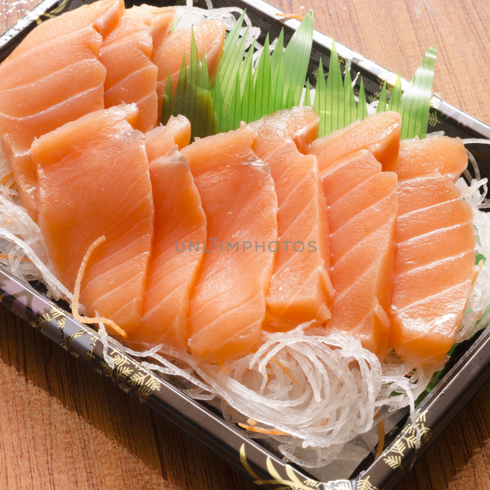 fresh salmon piece for sushi on wood background