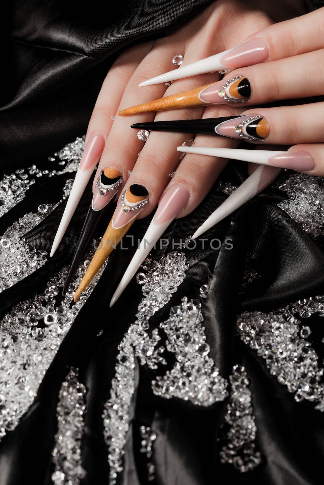 extremely long nails with nail-art and crystal jewellery,