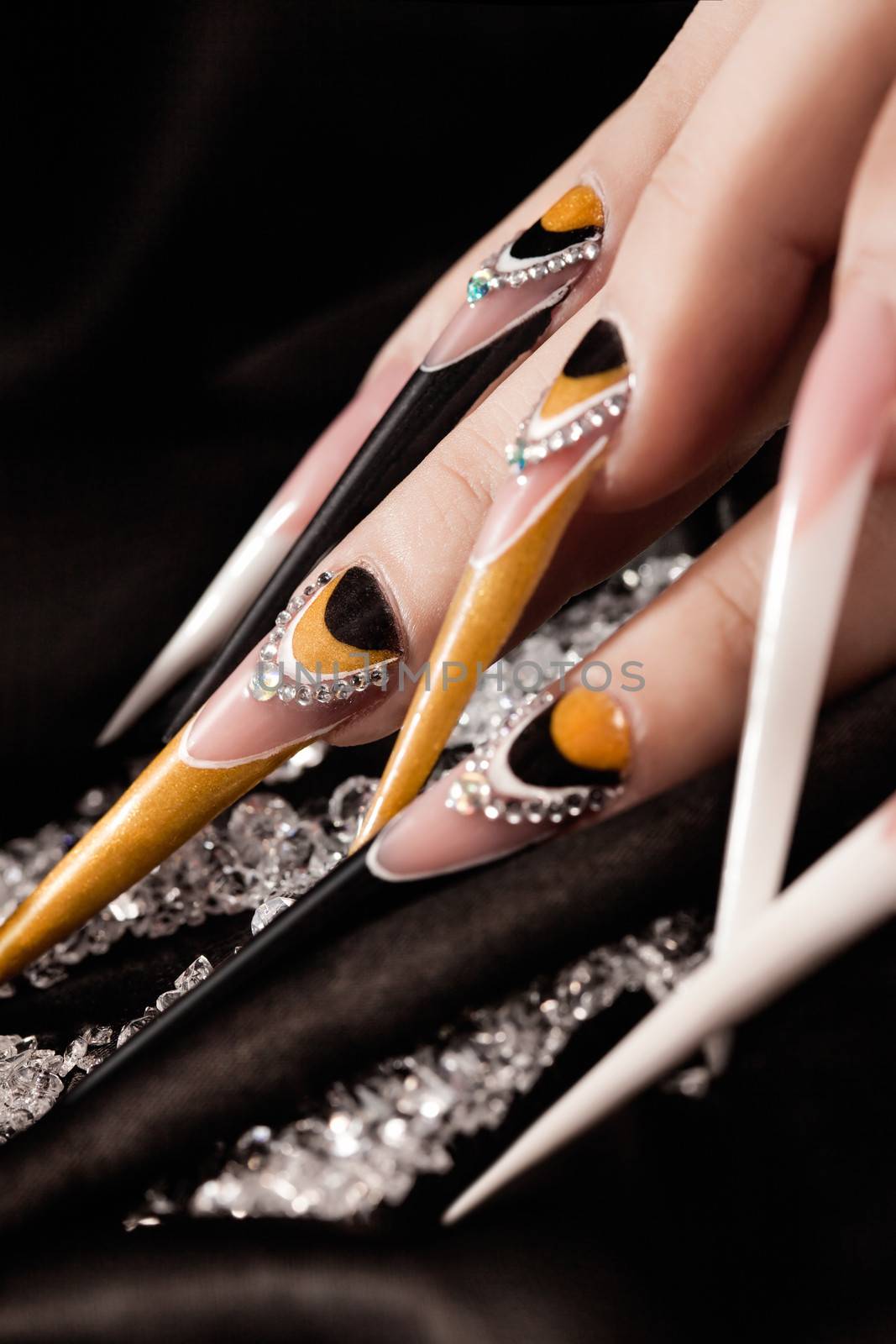 extremely long nails with nail-art and crystal jewellery,