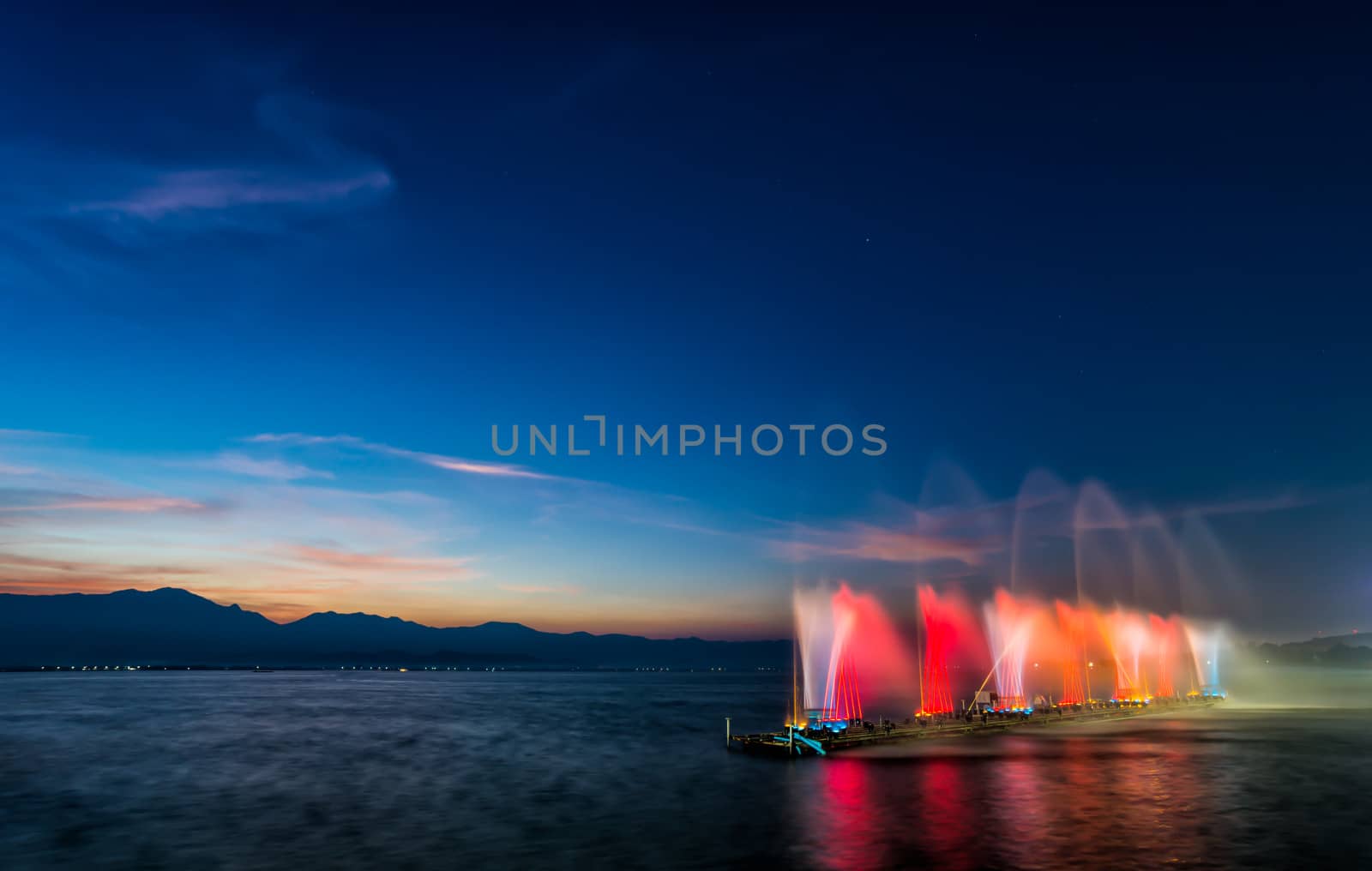 fountain on water in twilight time by moggara12