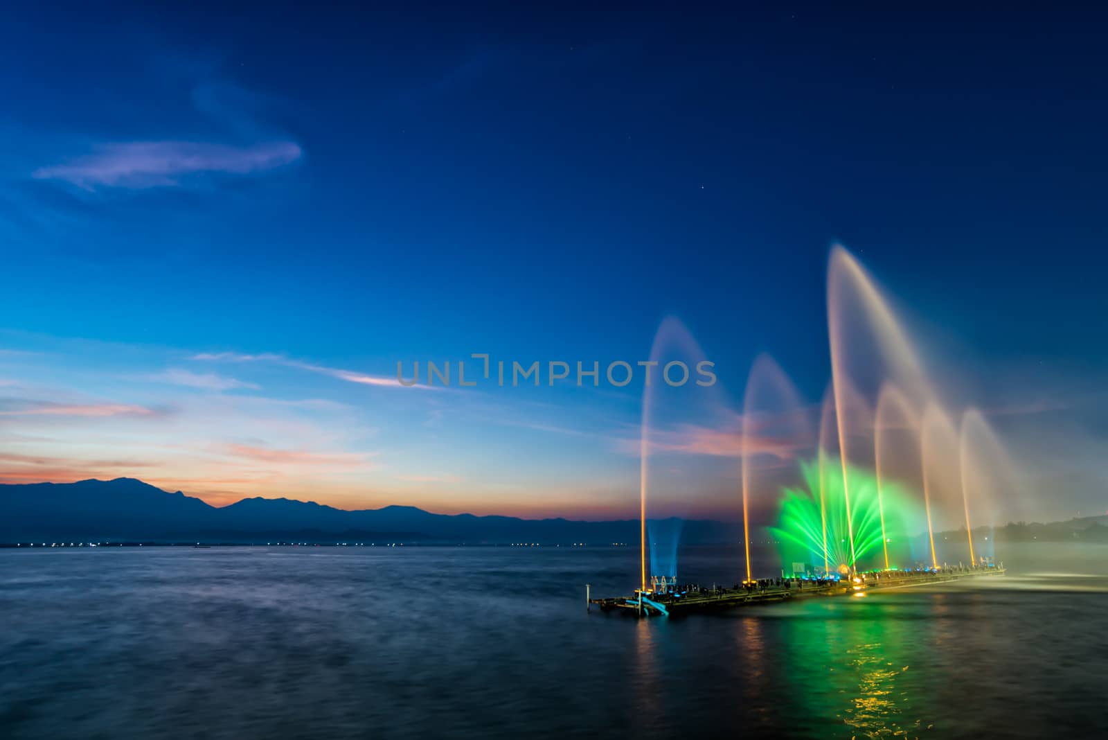fountain on water in twilight time by moggara12
