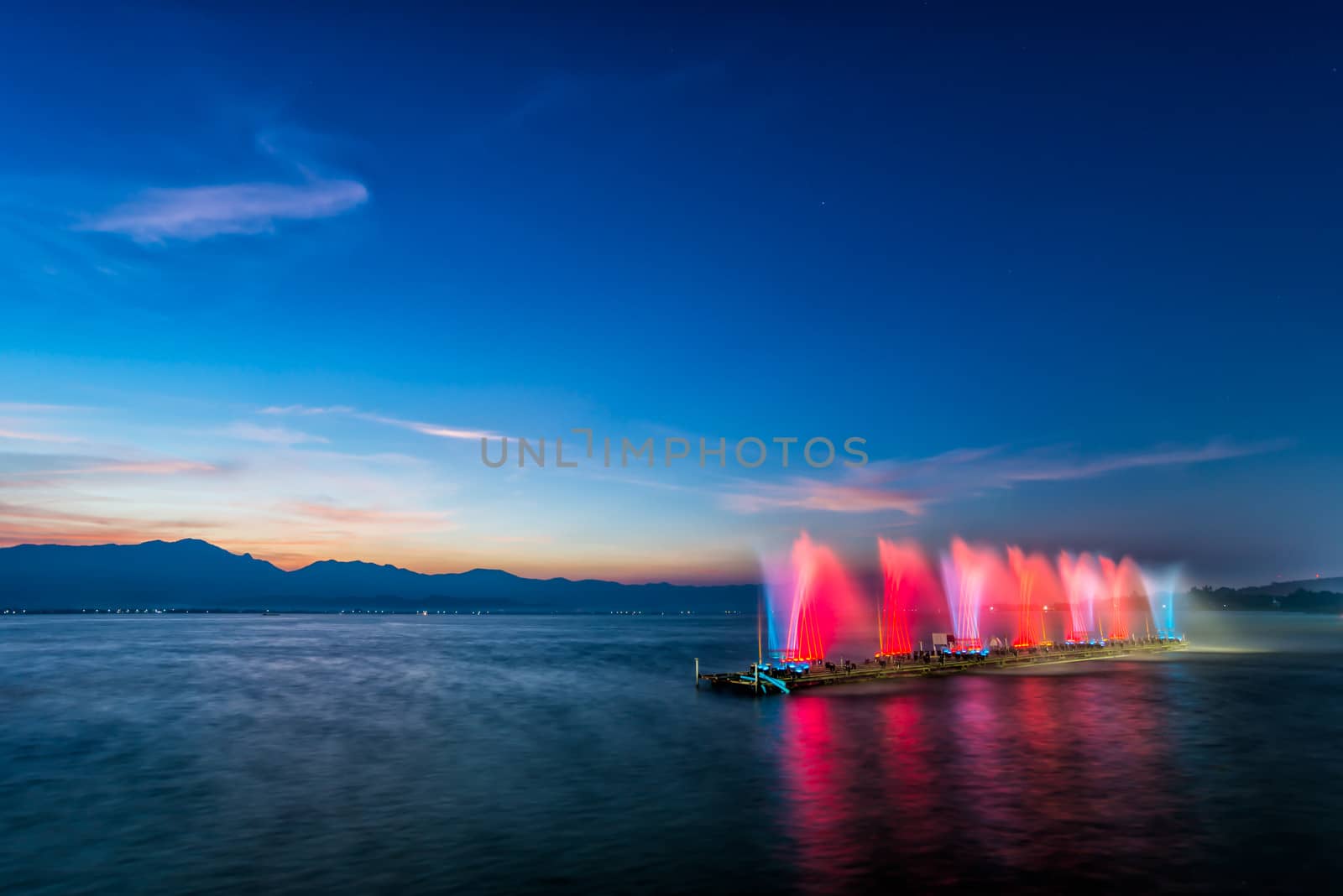 fountain on water in twilight time by moggara12