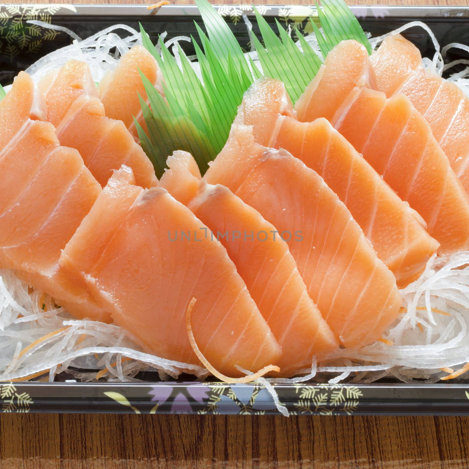 fresh salmon piece for sushi on wood background