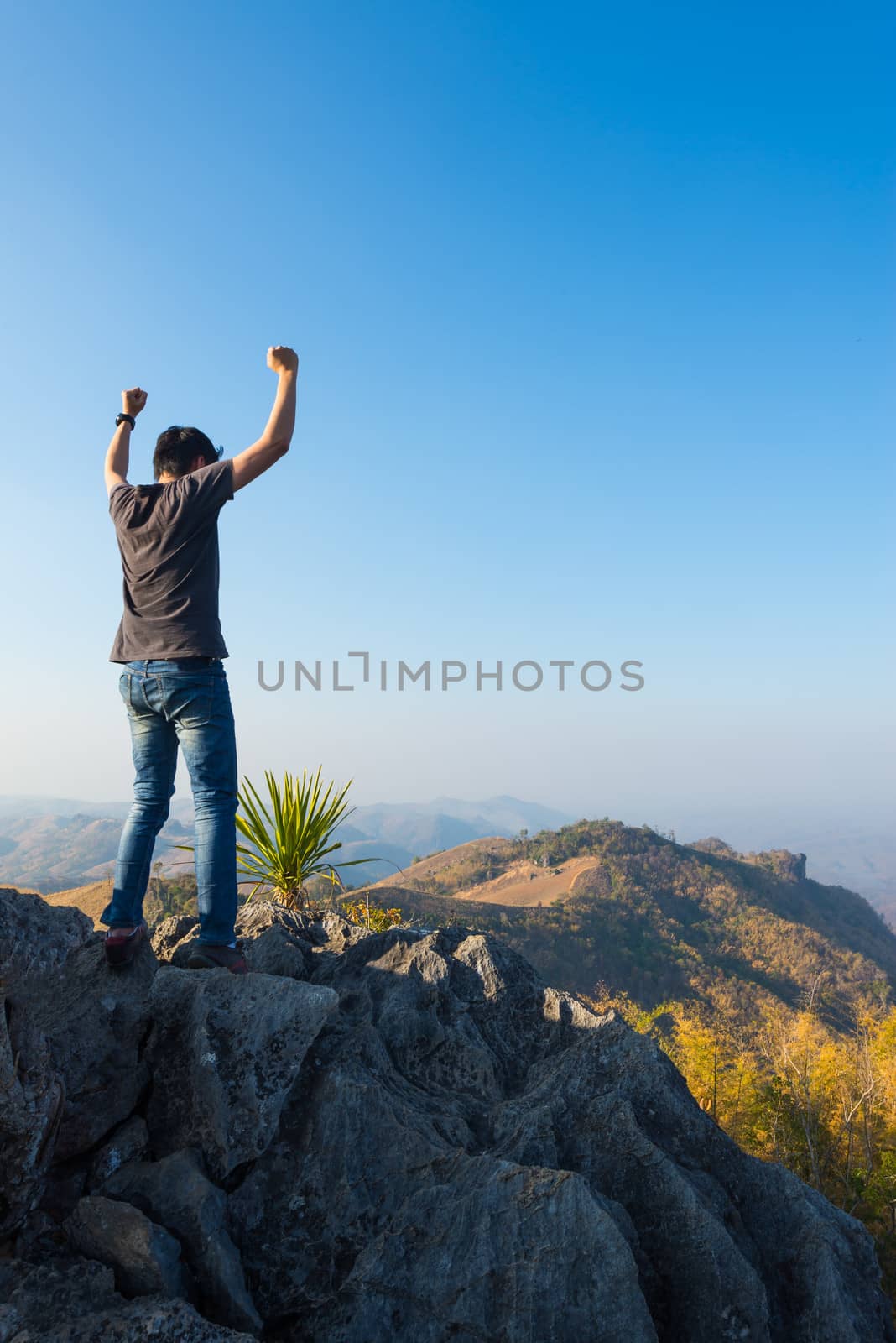 man on rock at mountain by moggara12