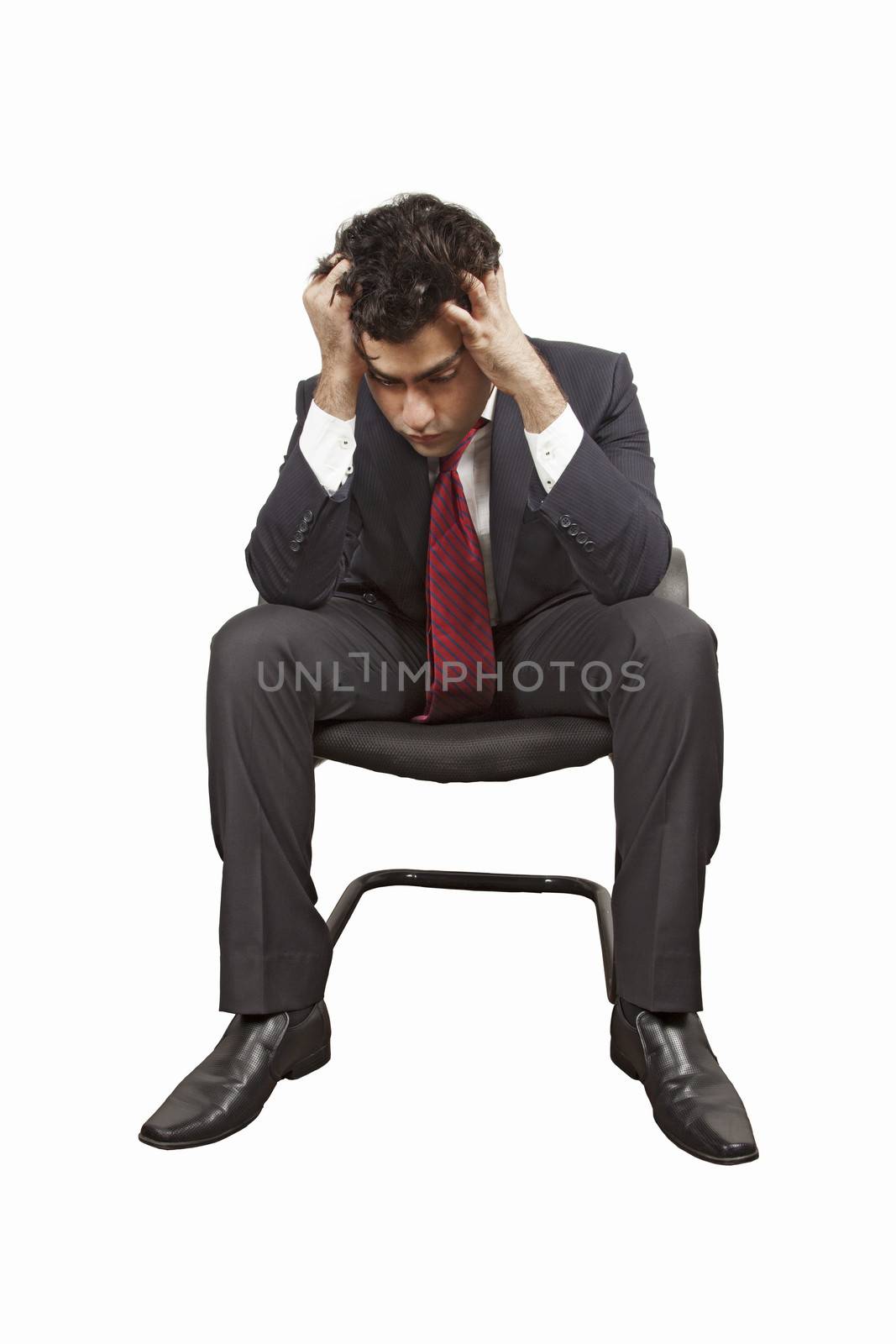 man sitting on a chair pulling his hair off by haiderazim