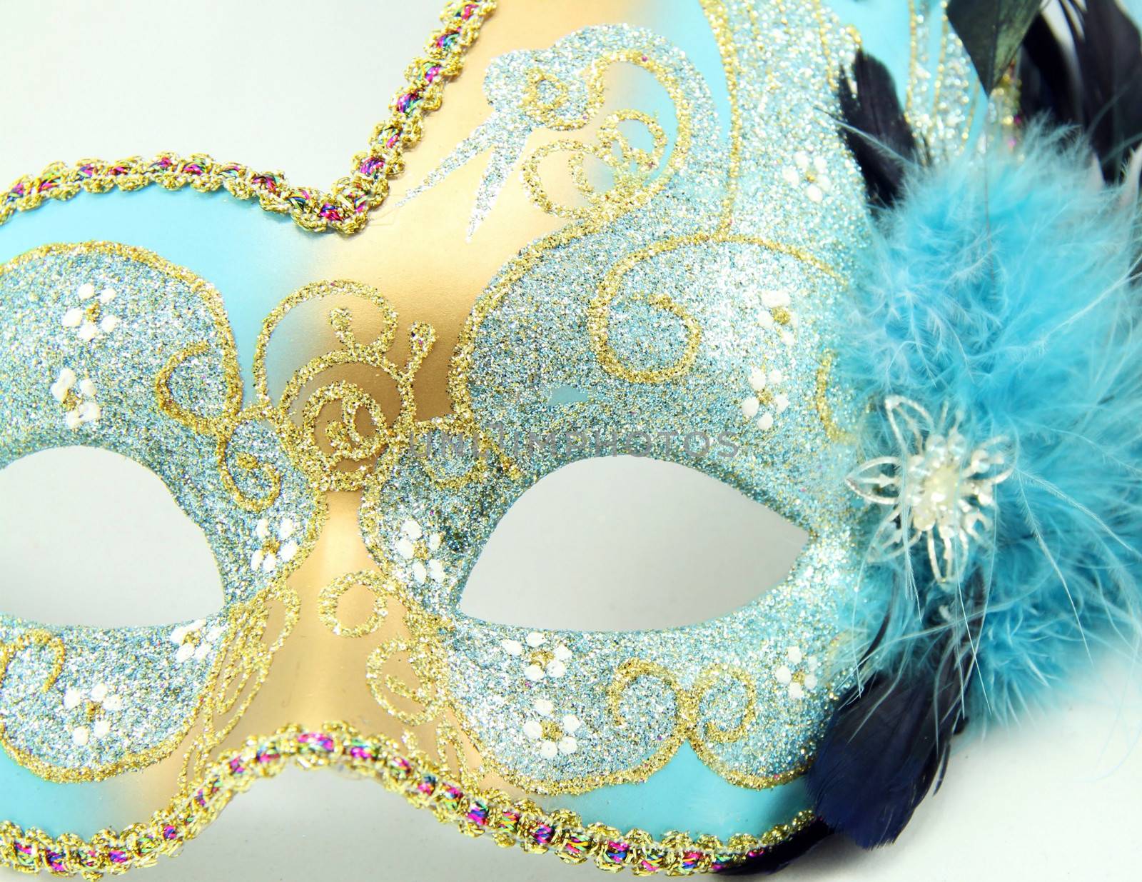 Close up of a Mardi Gras mask with jewels isolated on white background.