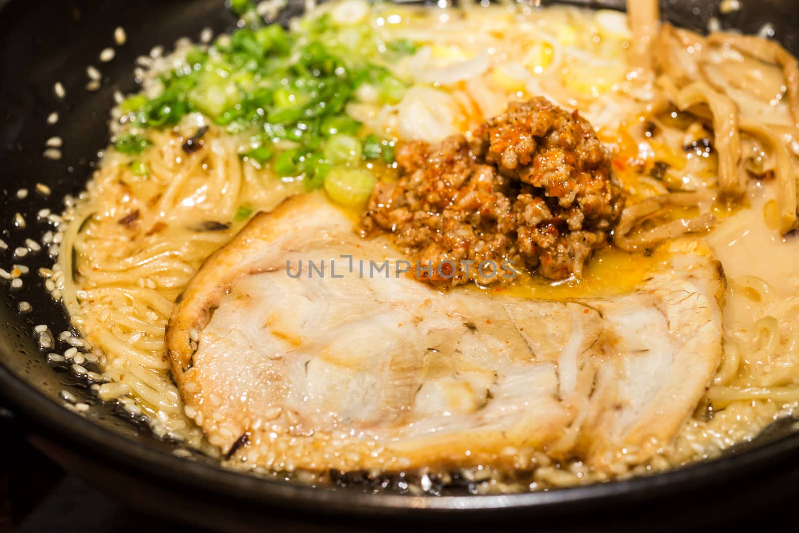 ramen japanese food style roasted pork and spicy ground pork sauce with onion sliceed noodle in soup sesame on topping