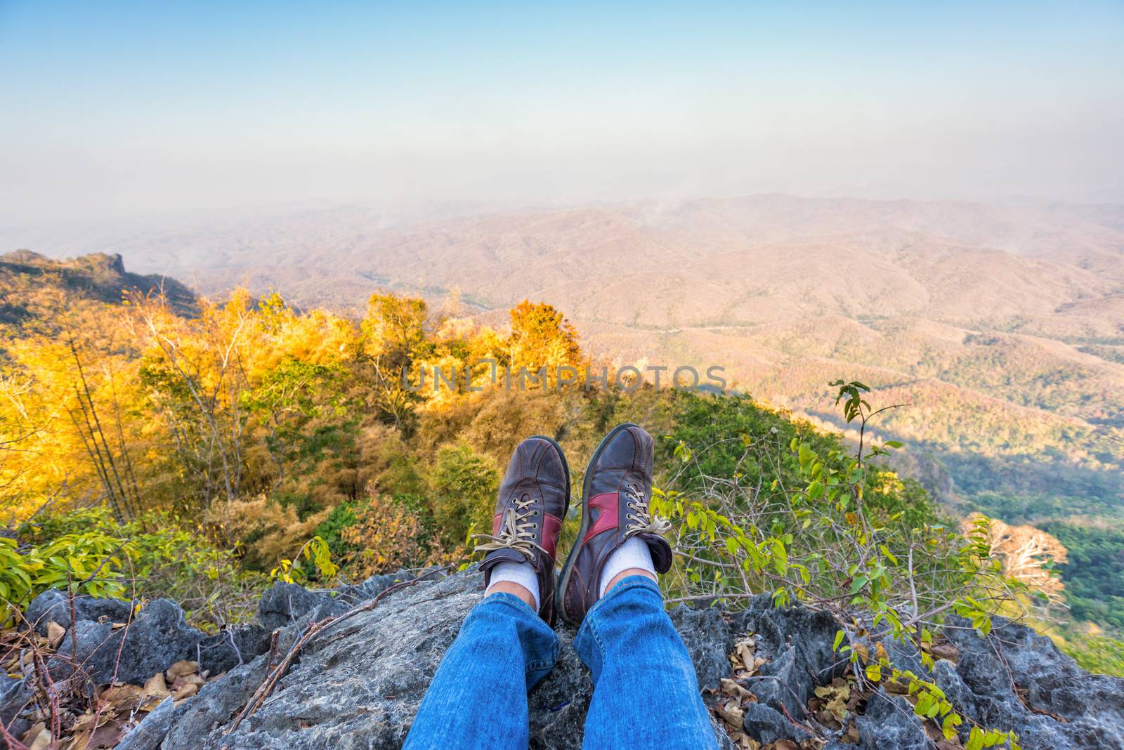 shoes of a man resting on high mountain