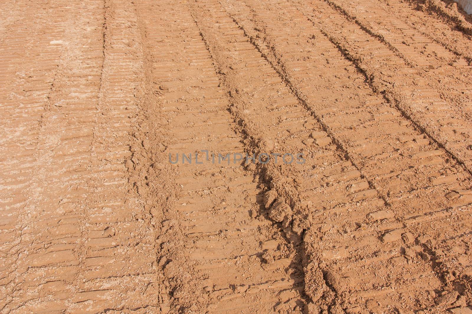 wheel tracks on dirt  by Sorapop