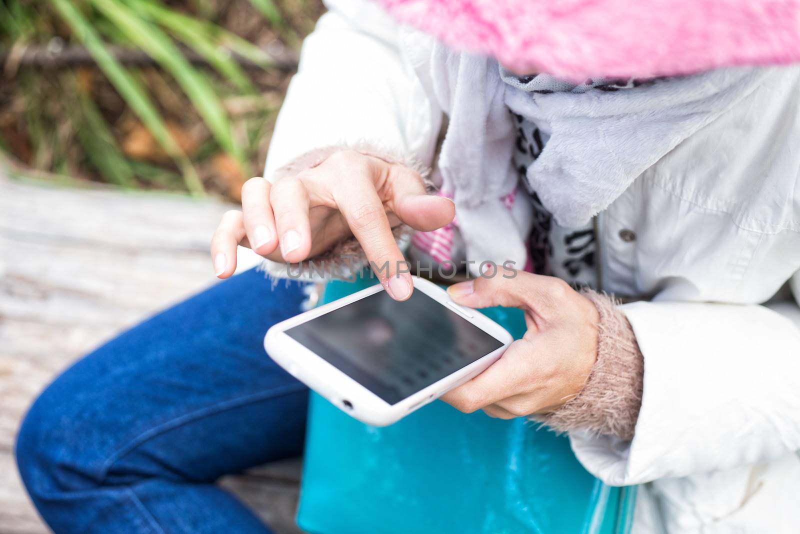 finger of girl touching screen on mobile phone